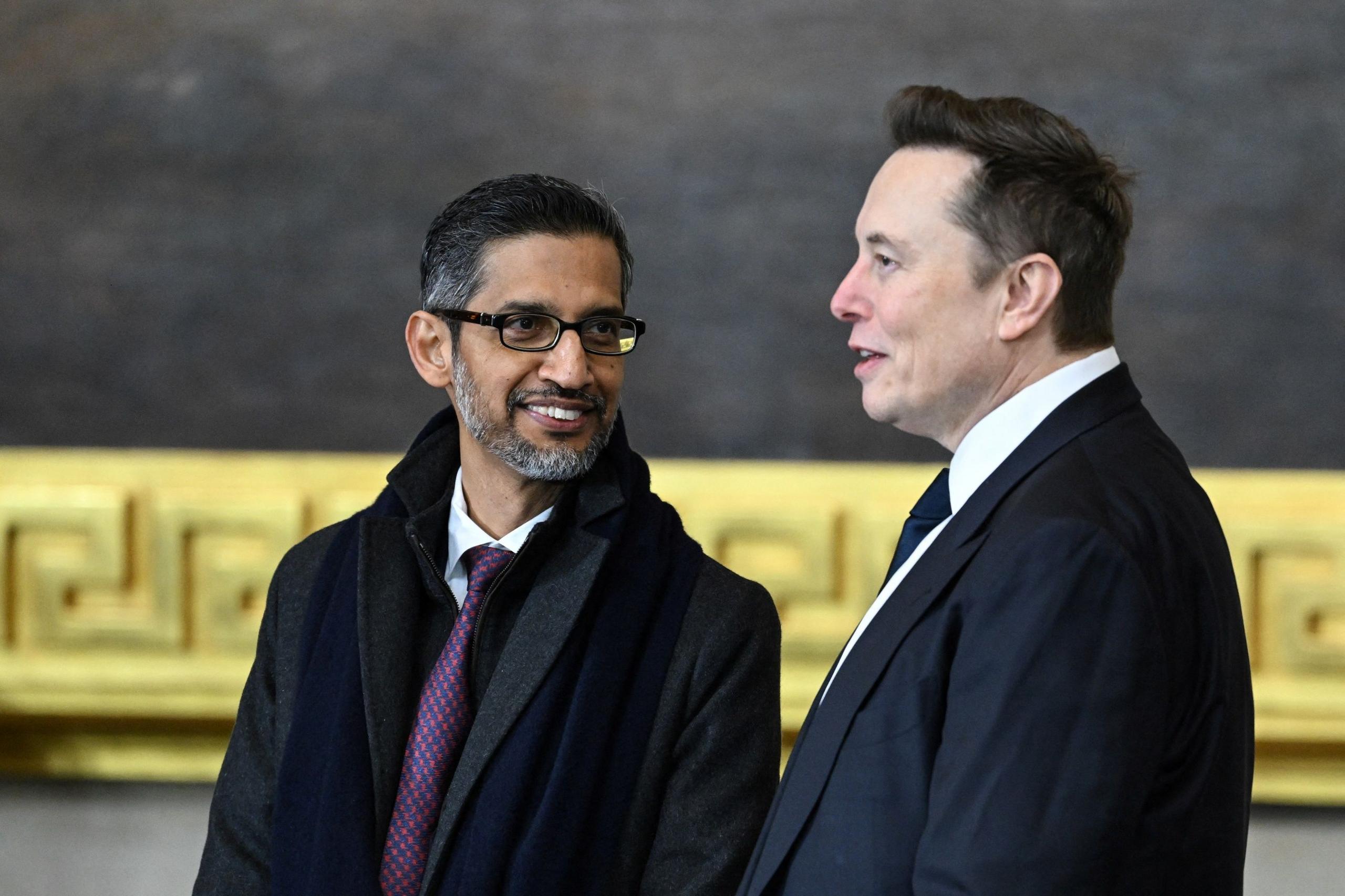 Google CEO Sundar Pichai speaks with Tesla and SpaceX CEO Elon Musk as they arrive for the inauguration ceremony 