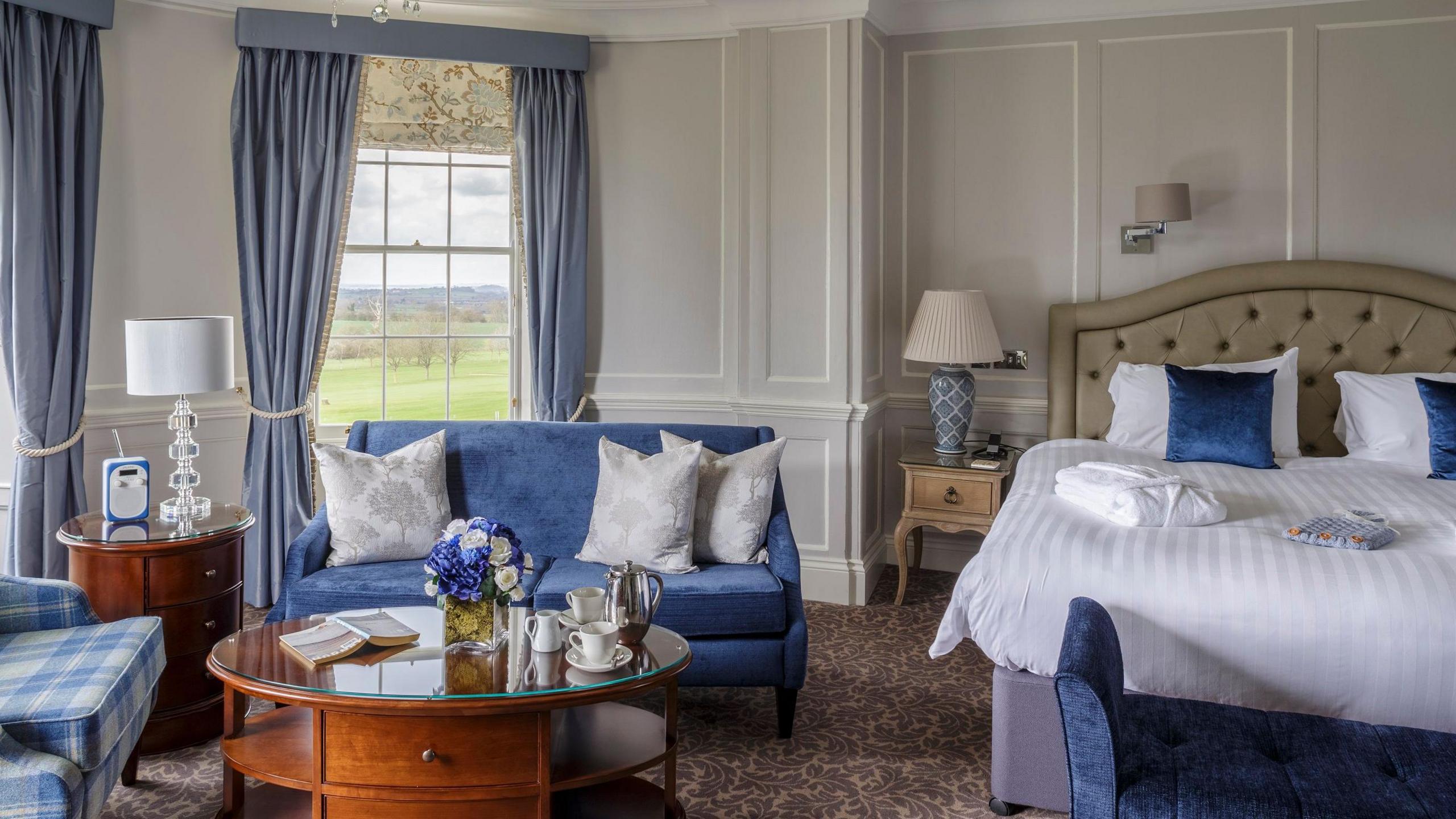 Bed in suite with big bay windows