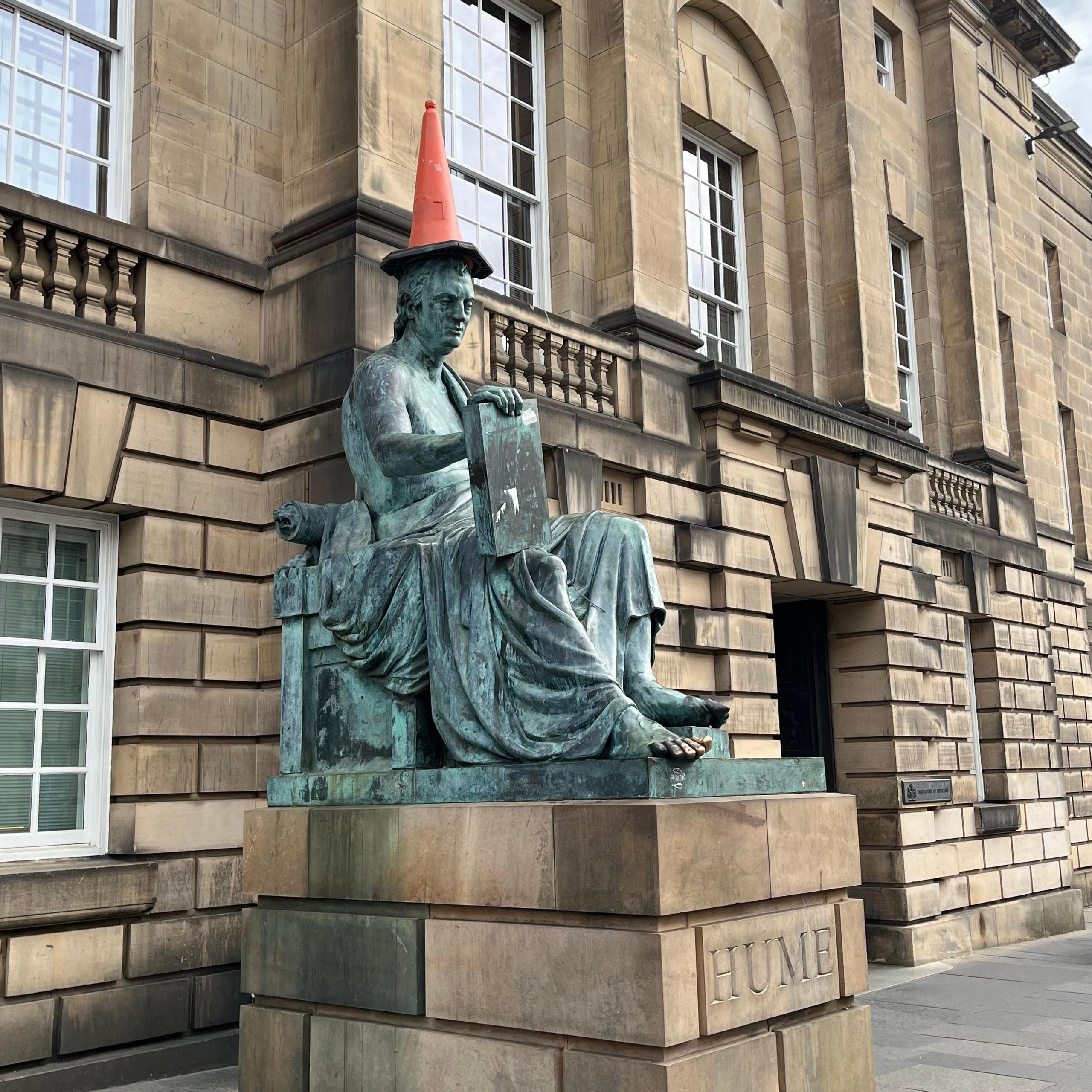 The David Hume statue on the Royal Mile with a cone on its head.