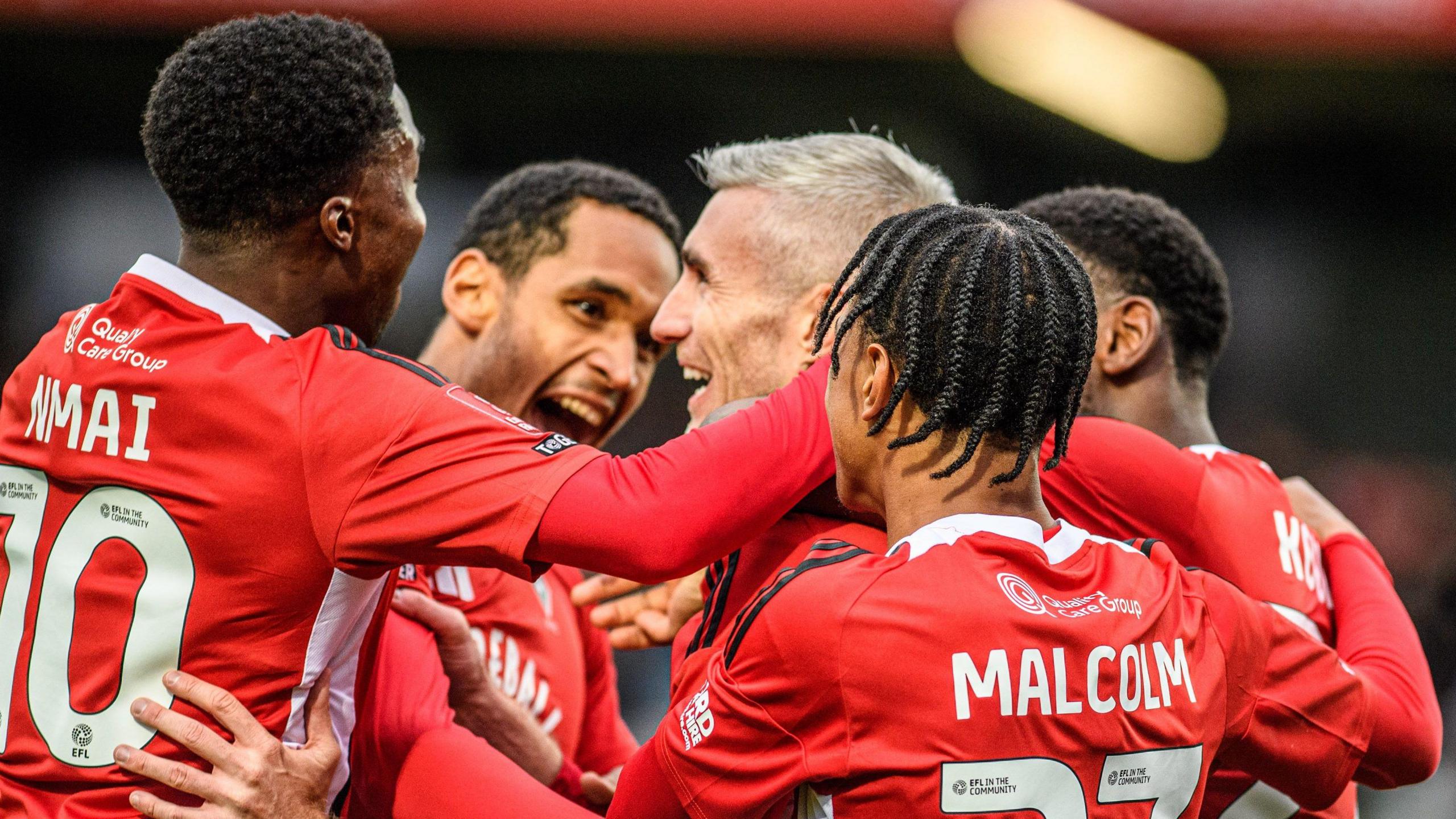 Salford City's players celebrate a goal