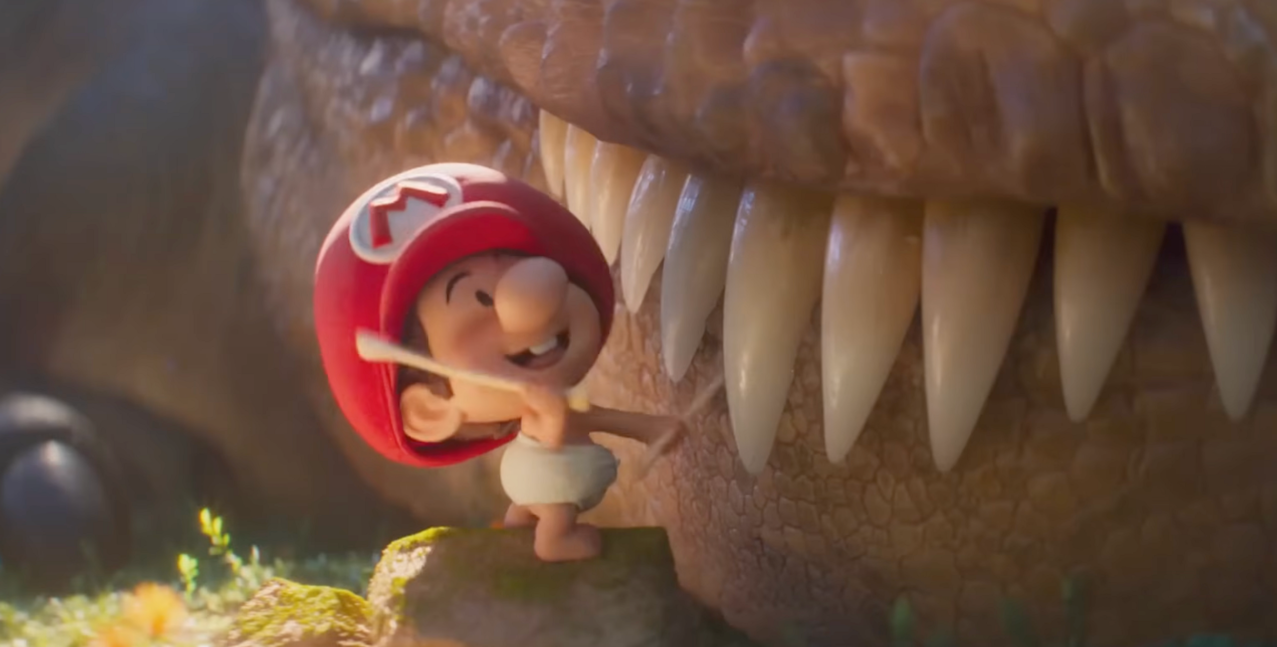 A small animated child in a nappy and mario hat next to a large dinosaur moth with sharp teeth. 