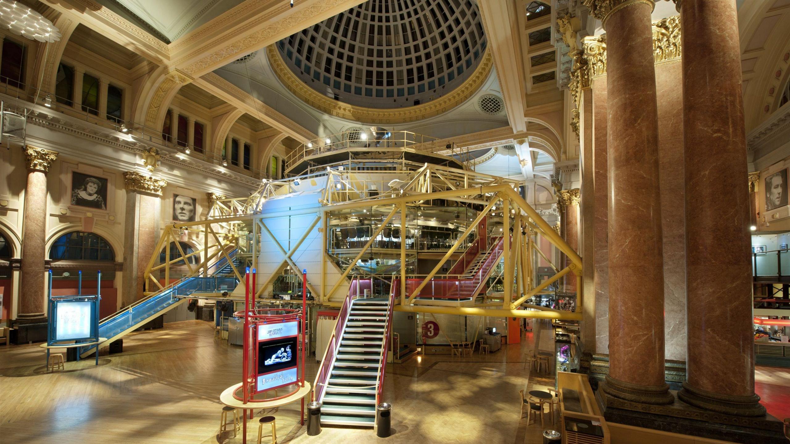 The steps and frame of the theatre, within a large grand hall with tall marble pillars and domed roof