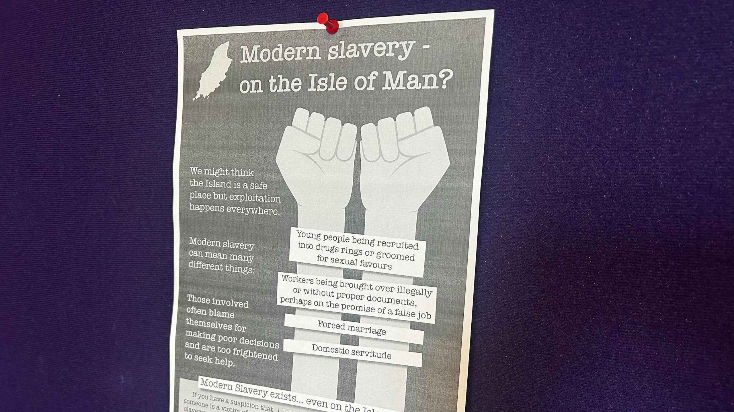 A One World Centre poster raising awareness about modern slavery. It details some of the forms it can take such as forced marriage. It has a cartoon drawing of a pair of hands with writing on the wrists to resemble shackles.