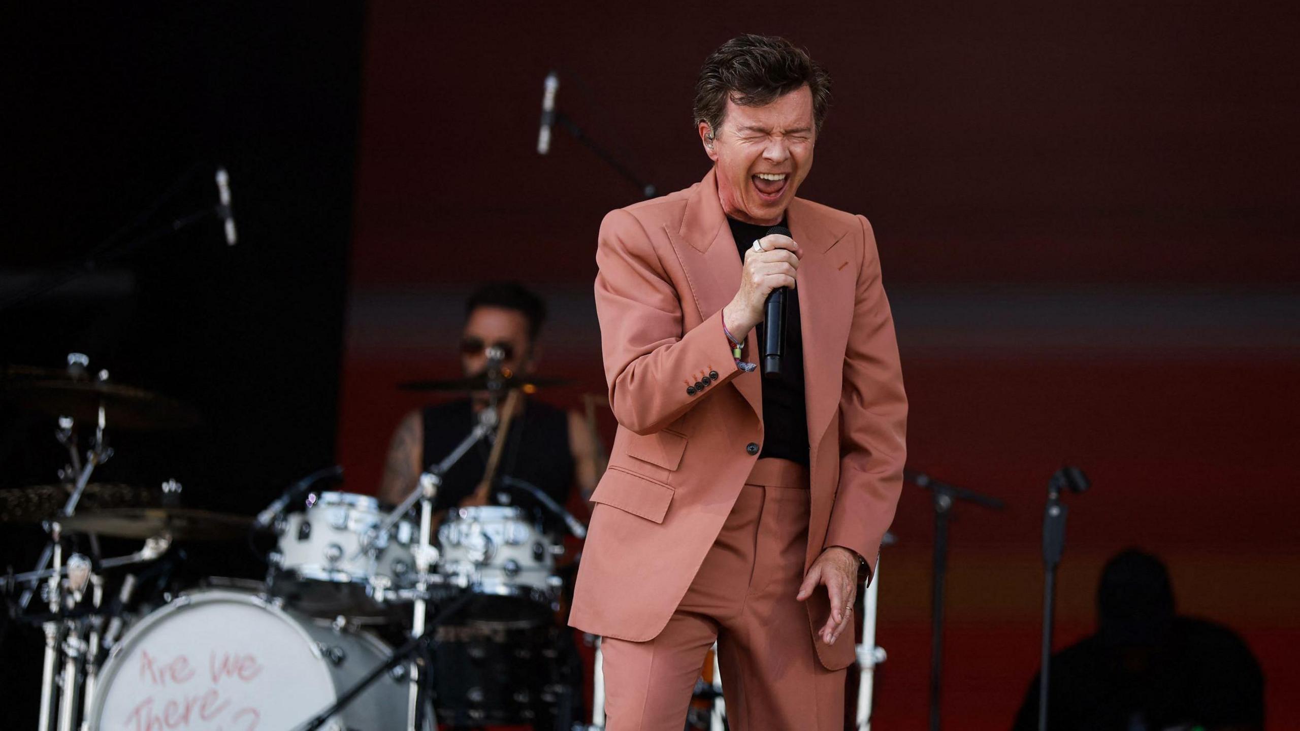 Rick Astley singing at the Glastonbury festival in 2023