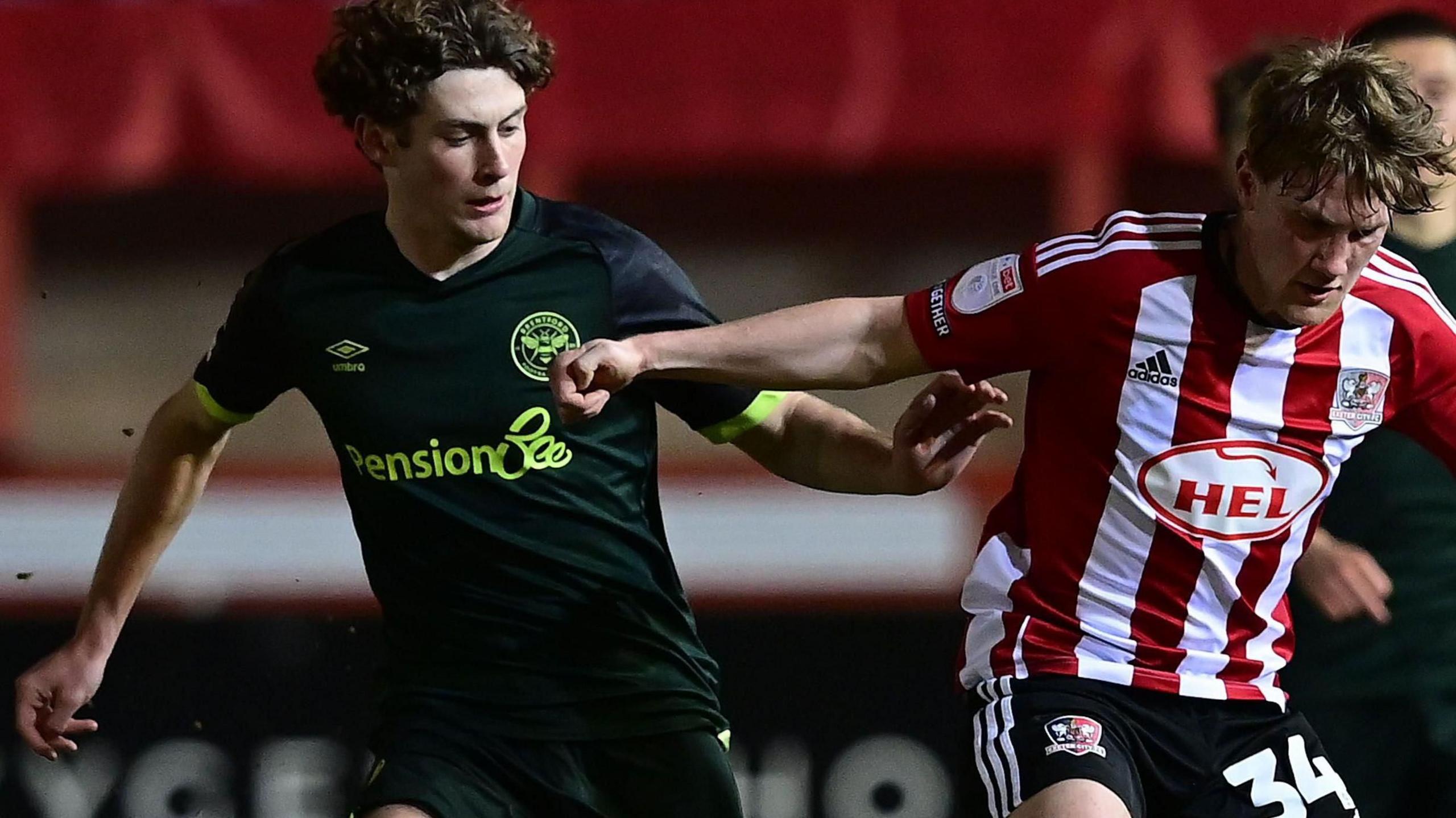 Ben Krauhaus challenges for the ball for Brentford v Exeter