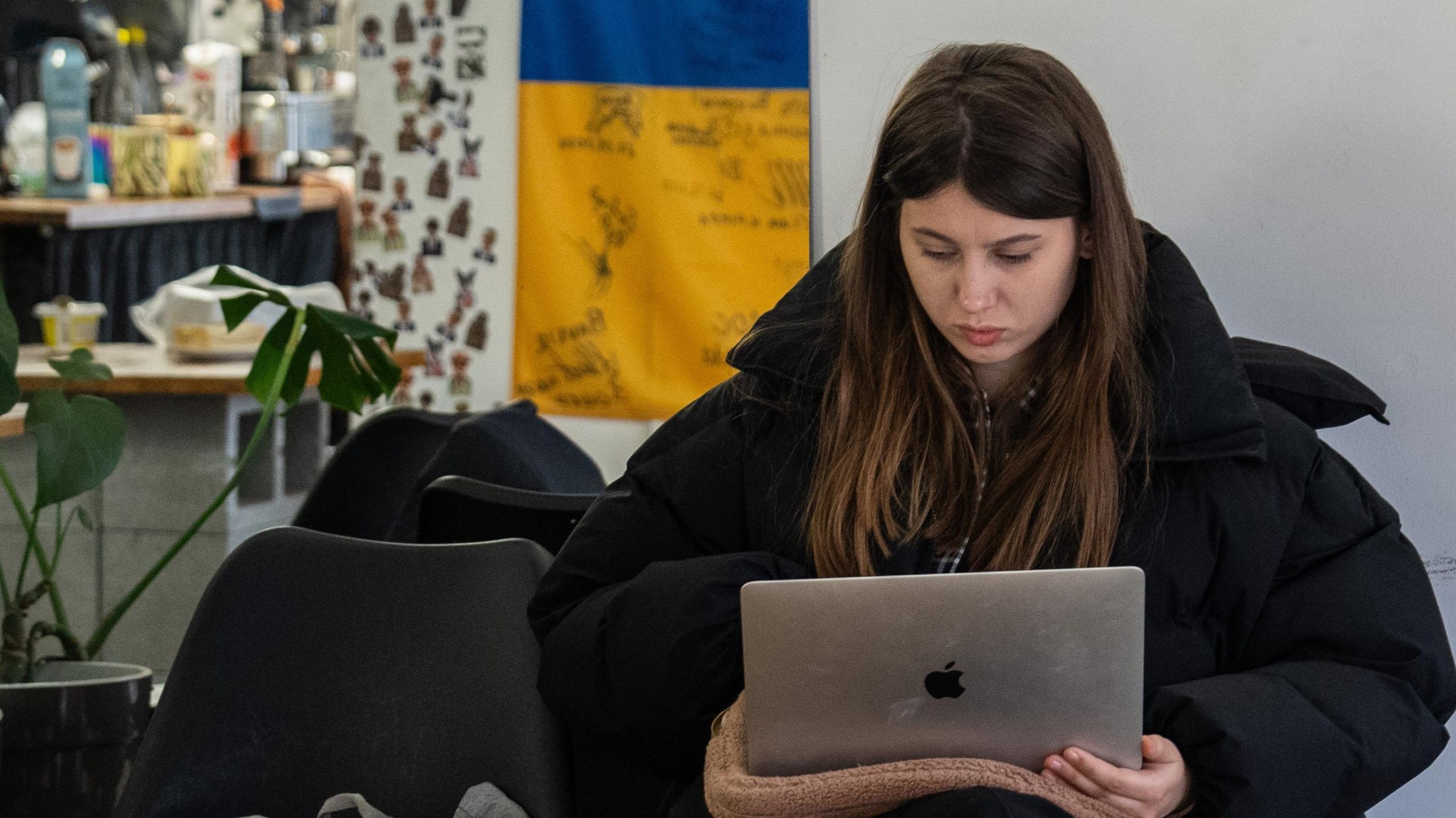 A woman works at her laptop in a cafe in Ukraine