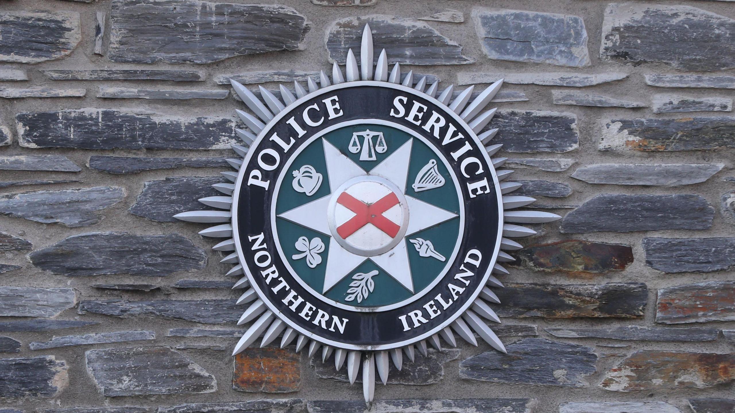 PSNI sign on a brick wall.