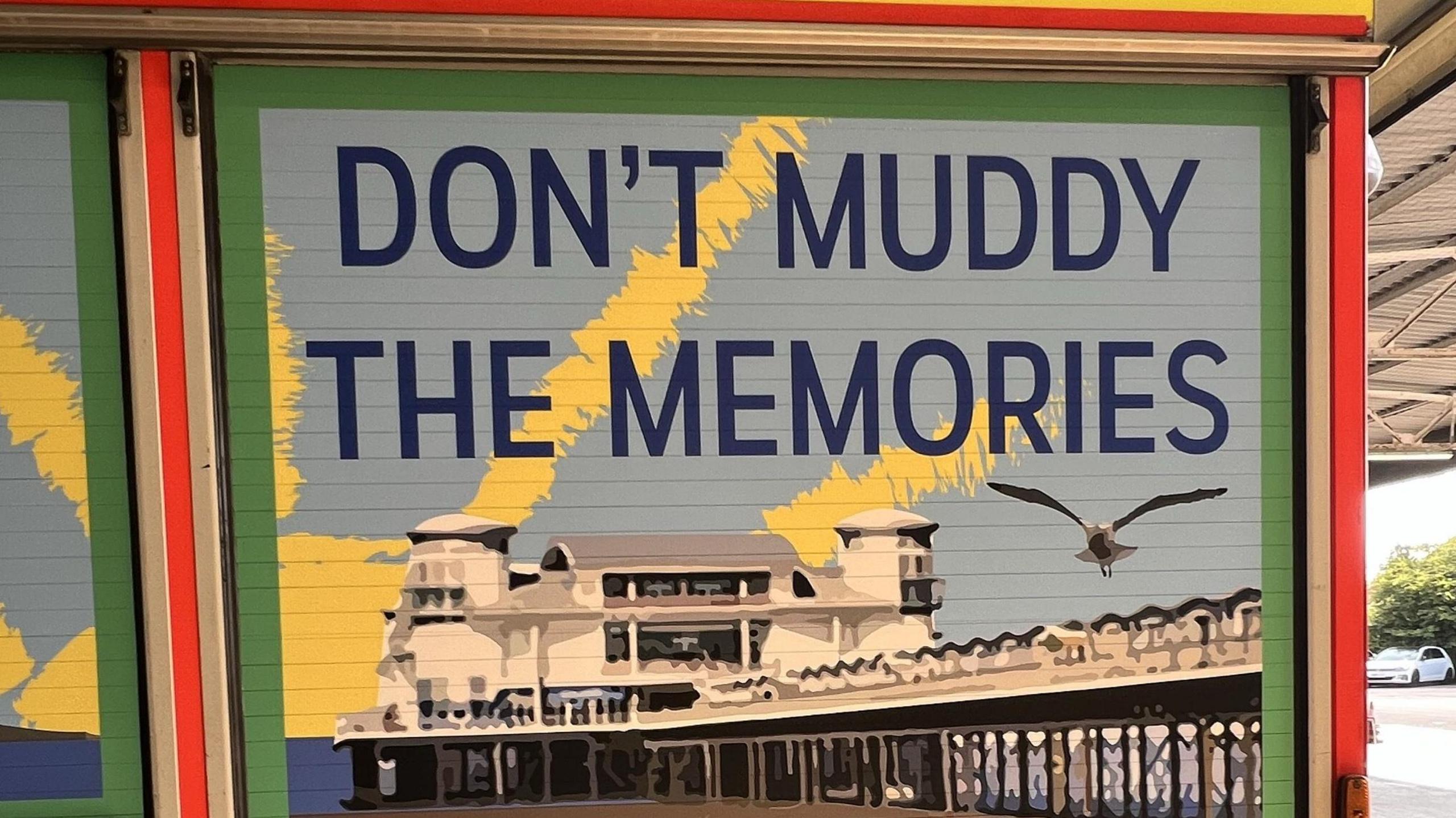 A mural on a fire engine, with an image of Weston's famous pier behind it and the phrase "Don't muddy the memories" 