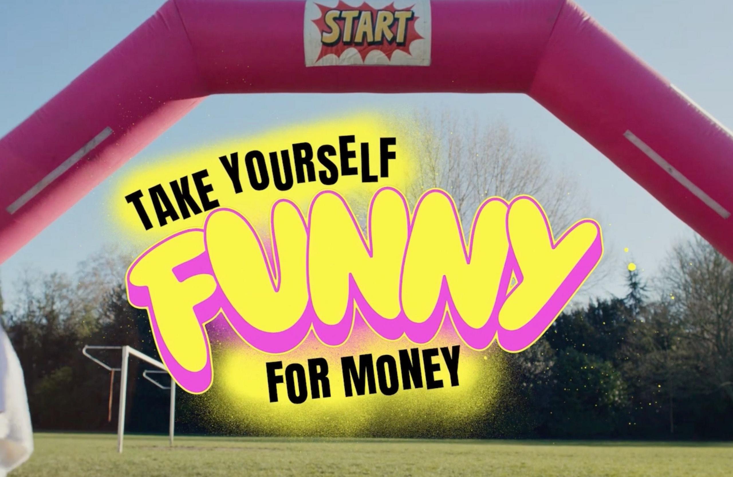 A bouncey castle on a playing field with the logo Take Yourself funny for money. 