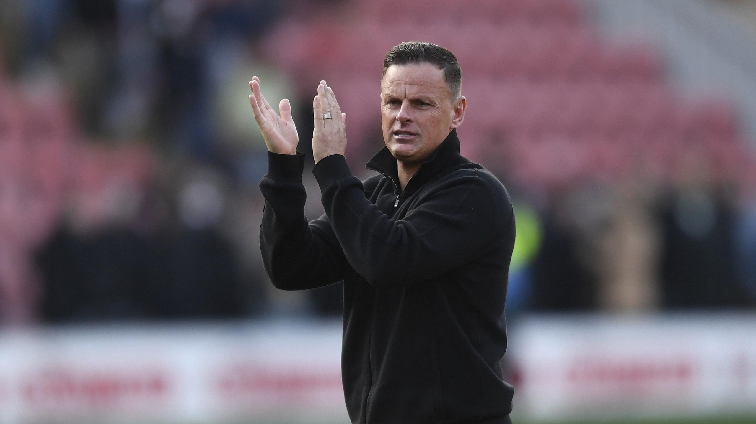 Leyton Orient head coach Richie Wellens applauds fans 