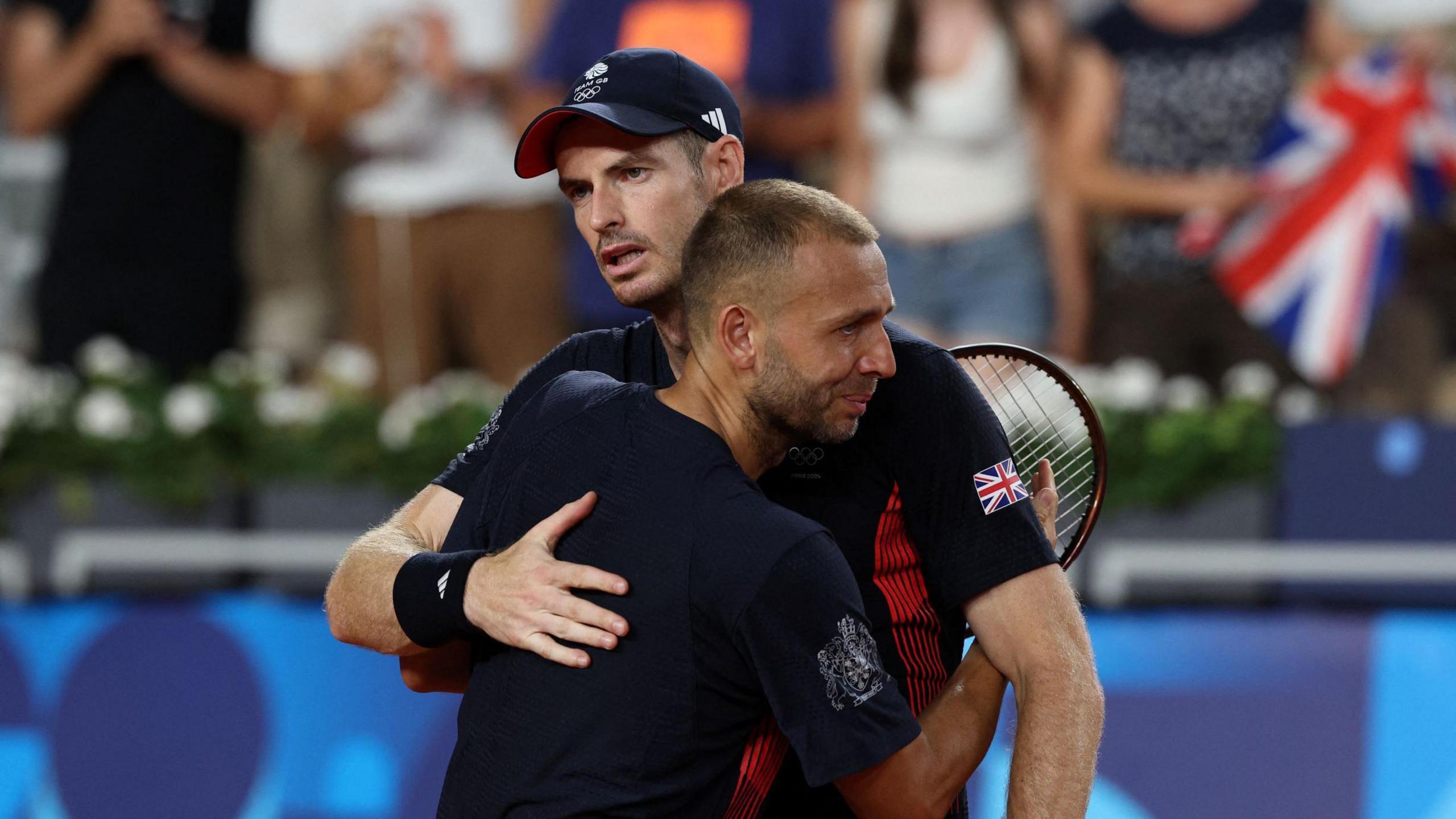 Sir Andy Murray and Dan Evans hug after being knocked out the men's doubles