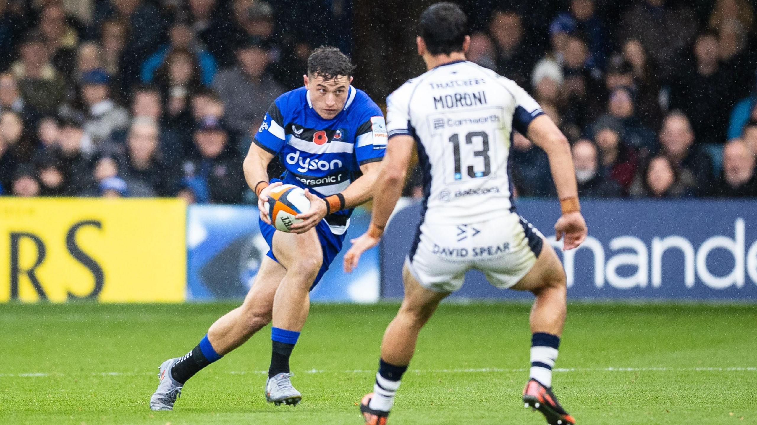 Henry Arundell runs towards Matias Moroni with the ball in both hands during a match for Bath against Bristol 