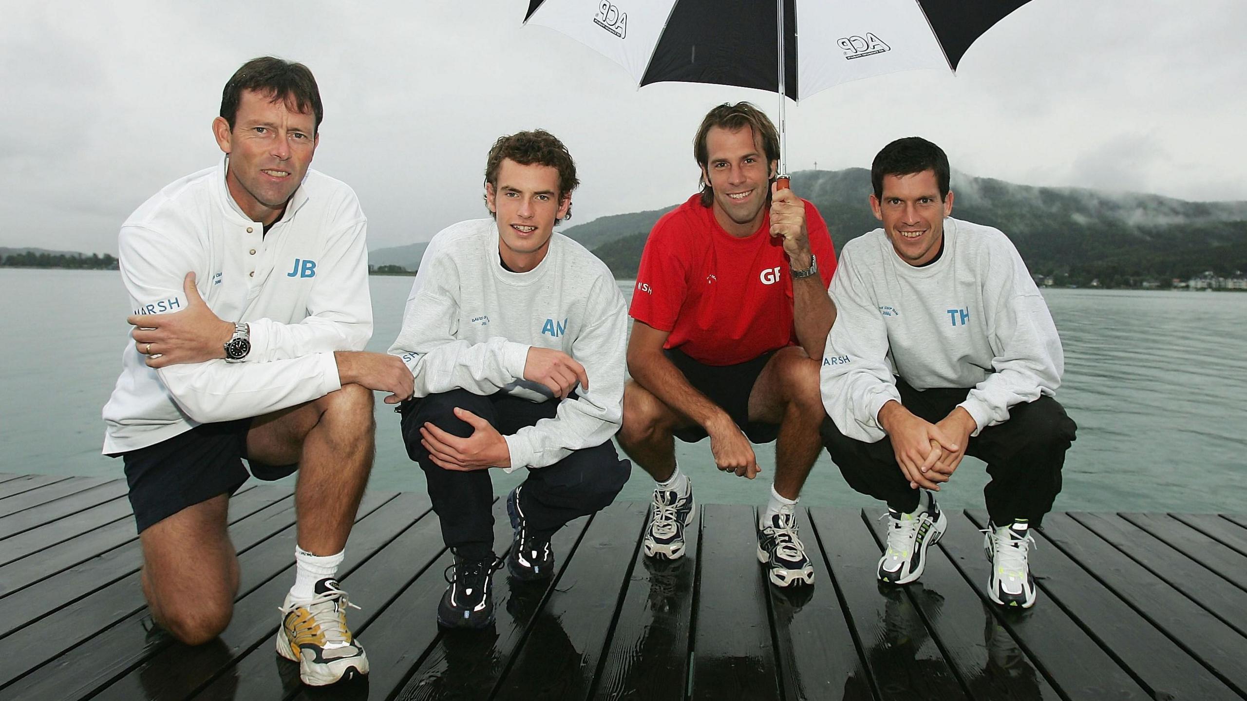 Jeremy Bates, Andy Murray, Greg Rusedski and Tim Henman pose by water on a Davis Cup trip to Austria