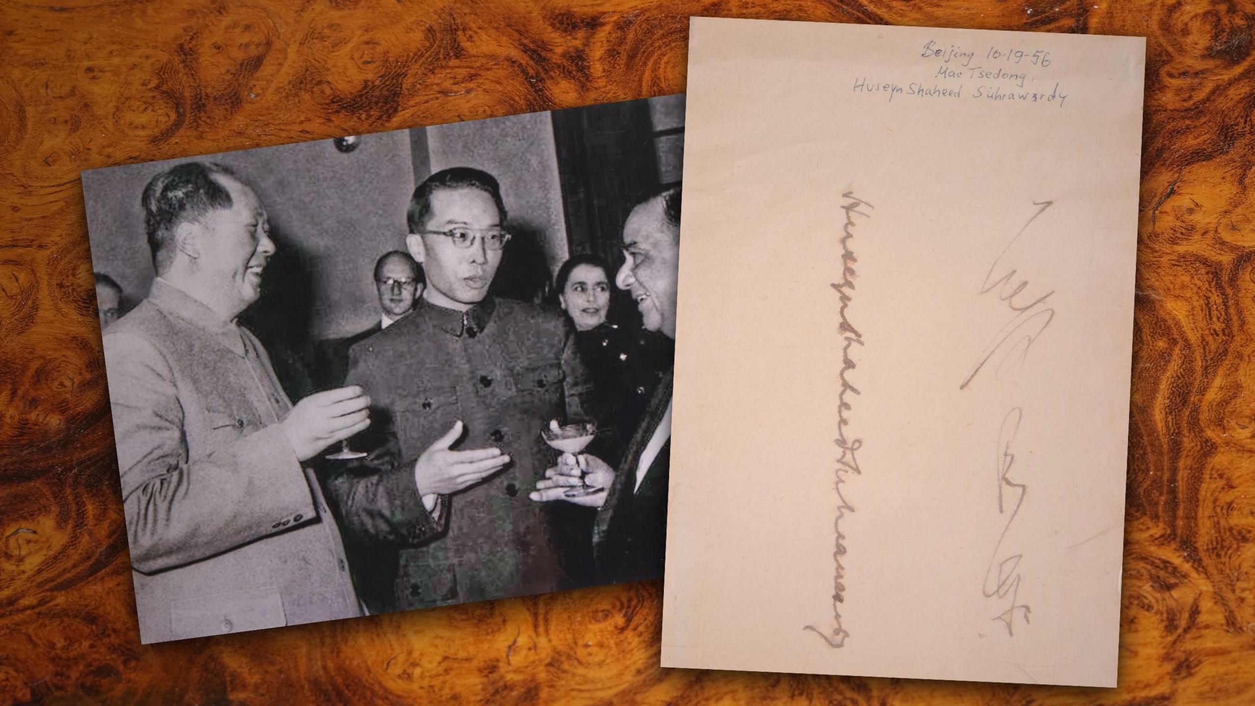 On picture on the right of Mao Zedong talking with another chines official and the then PM of Pakistan. On the right hand side is a sheet of paper with Zedong's signature.