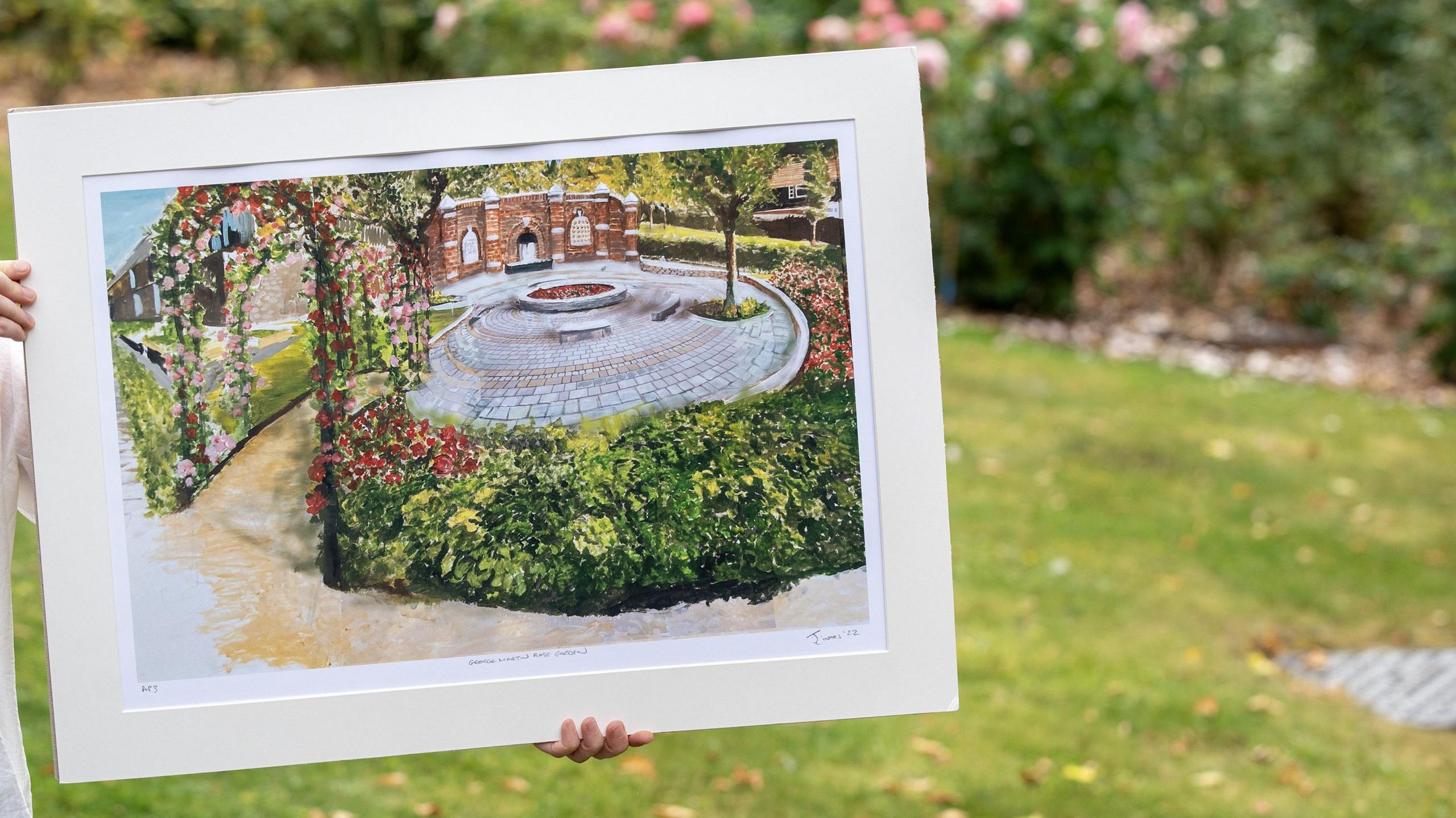 An artist's impression of how the rose garden will look is held in a frame at the location.