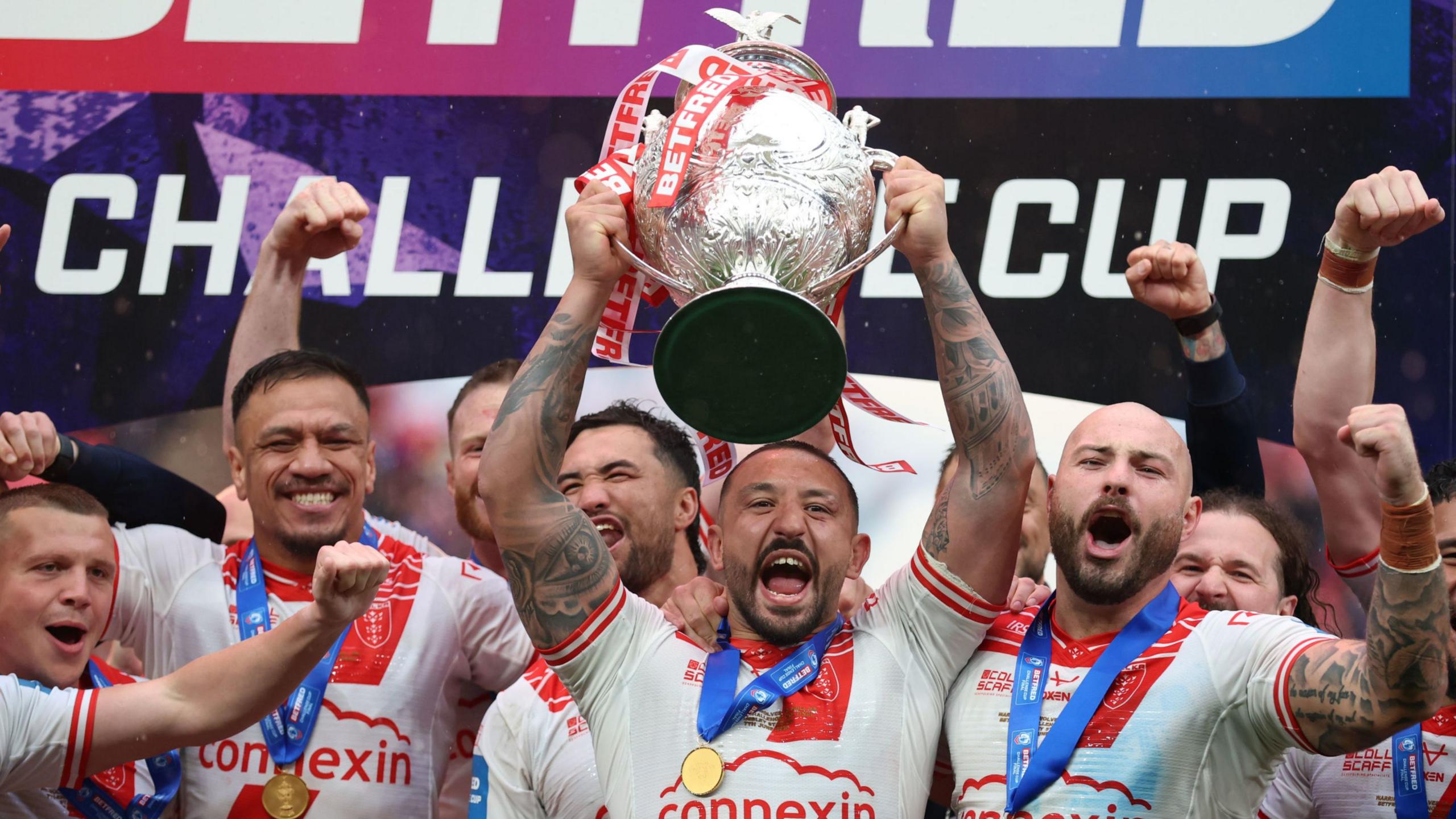 Hull KR captain Elliot Minchella lifts the Challenge Cup