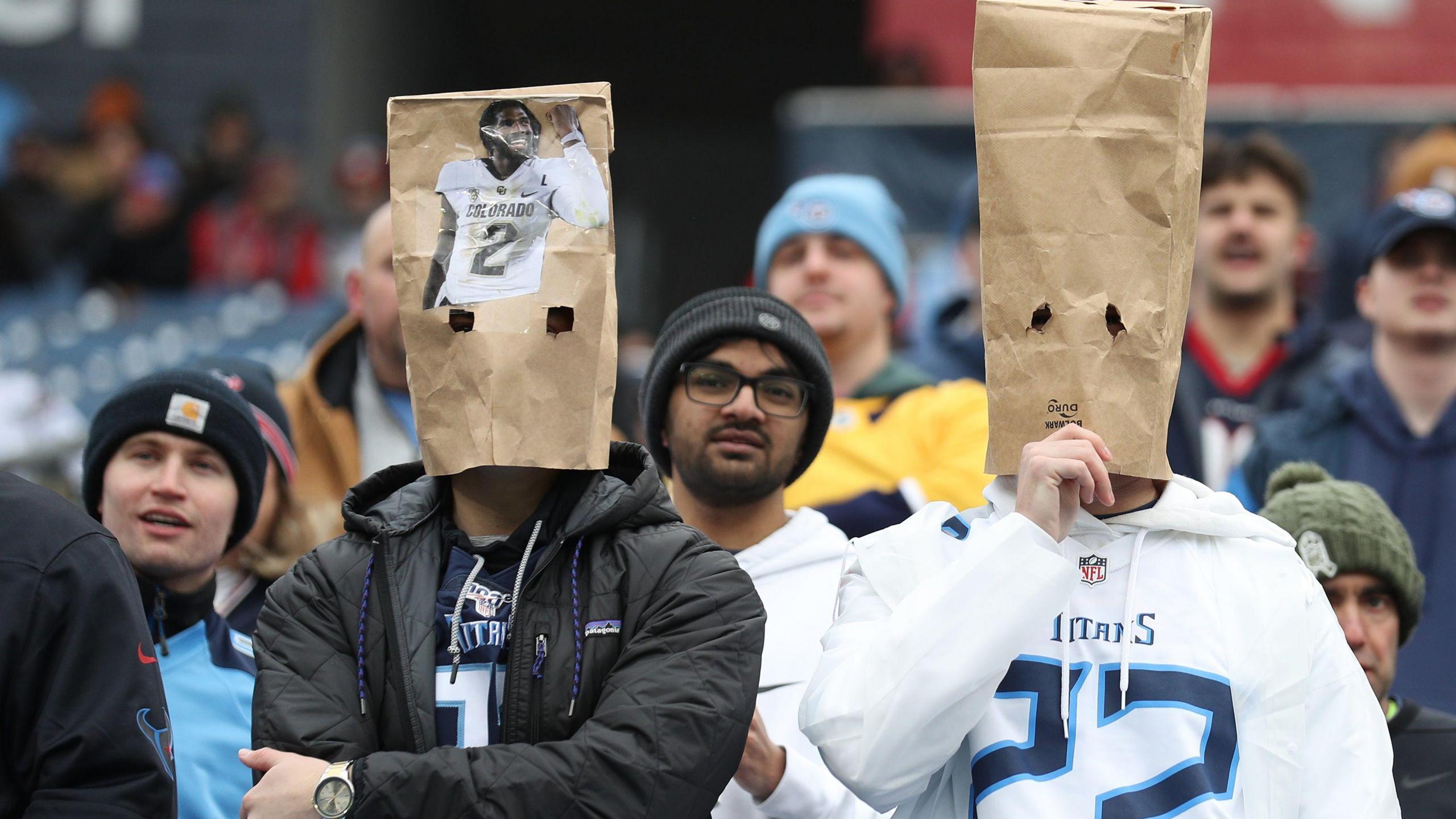 Tennessee Titans fans with paper bags over their heads