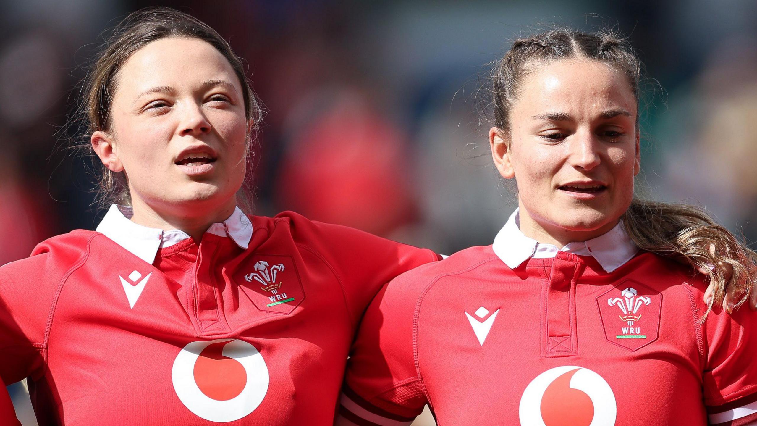 Alisha Joyce-Butchers and Jasmine Joyce-Butchers sing the national anthem side by side before a Wales game