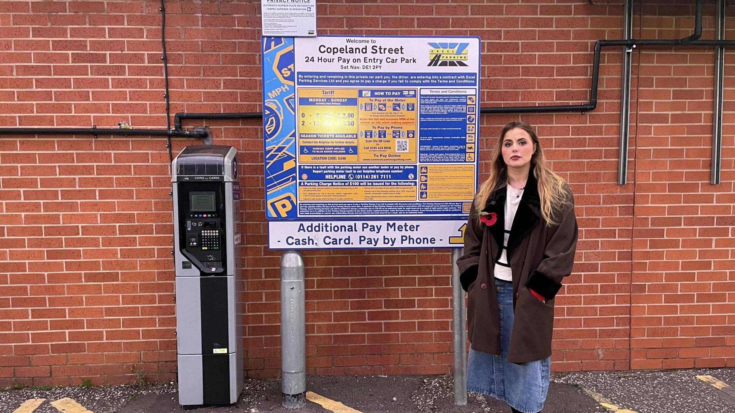 Rosey Hudson standing by a car park paying machine in Copeland Street, Derby