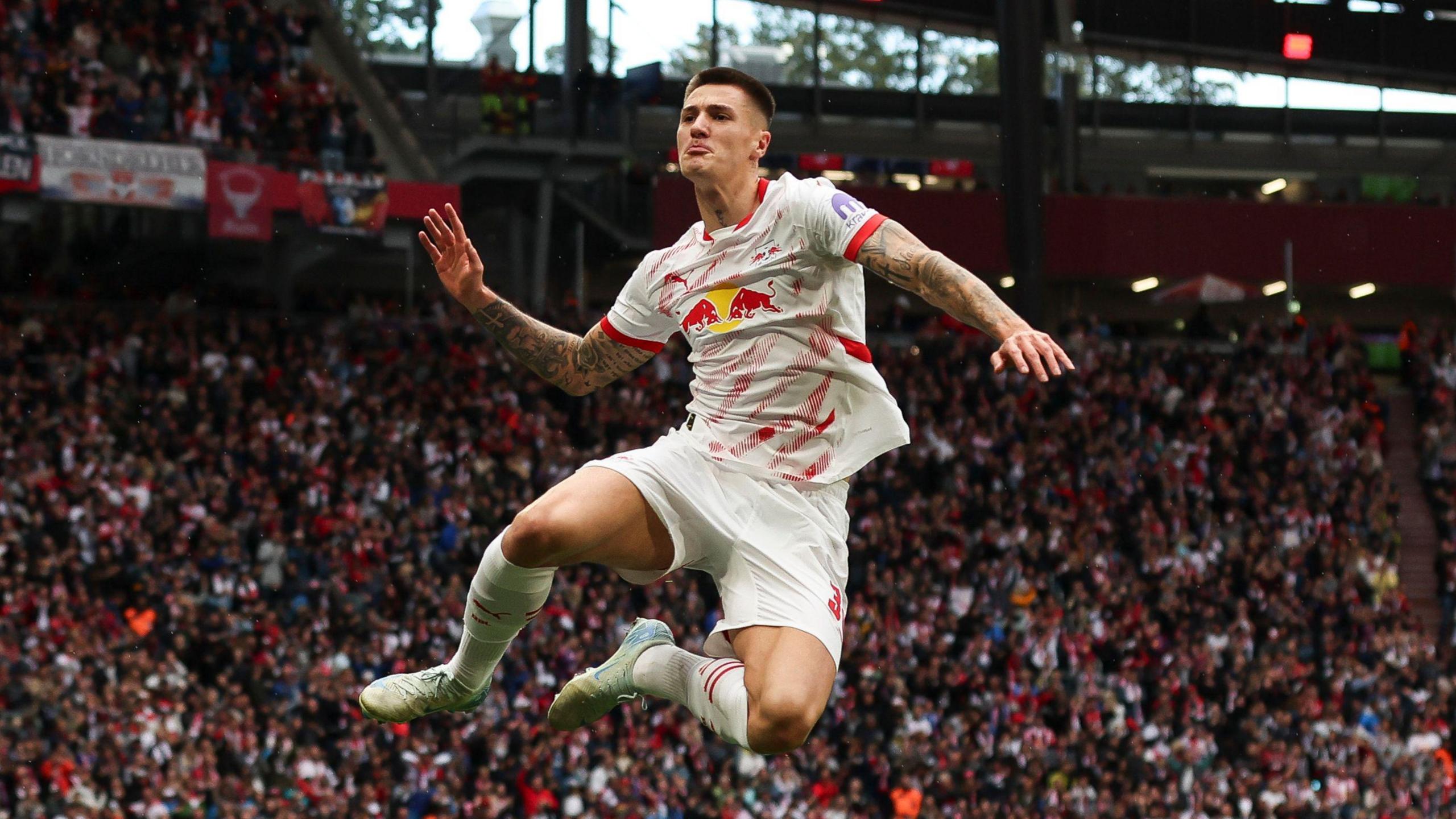 Benjamin Sesko jumps into the air in celebration