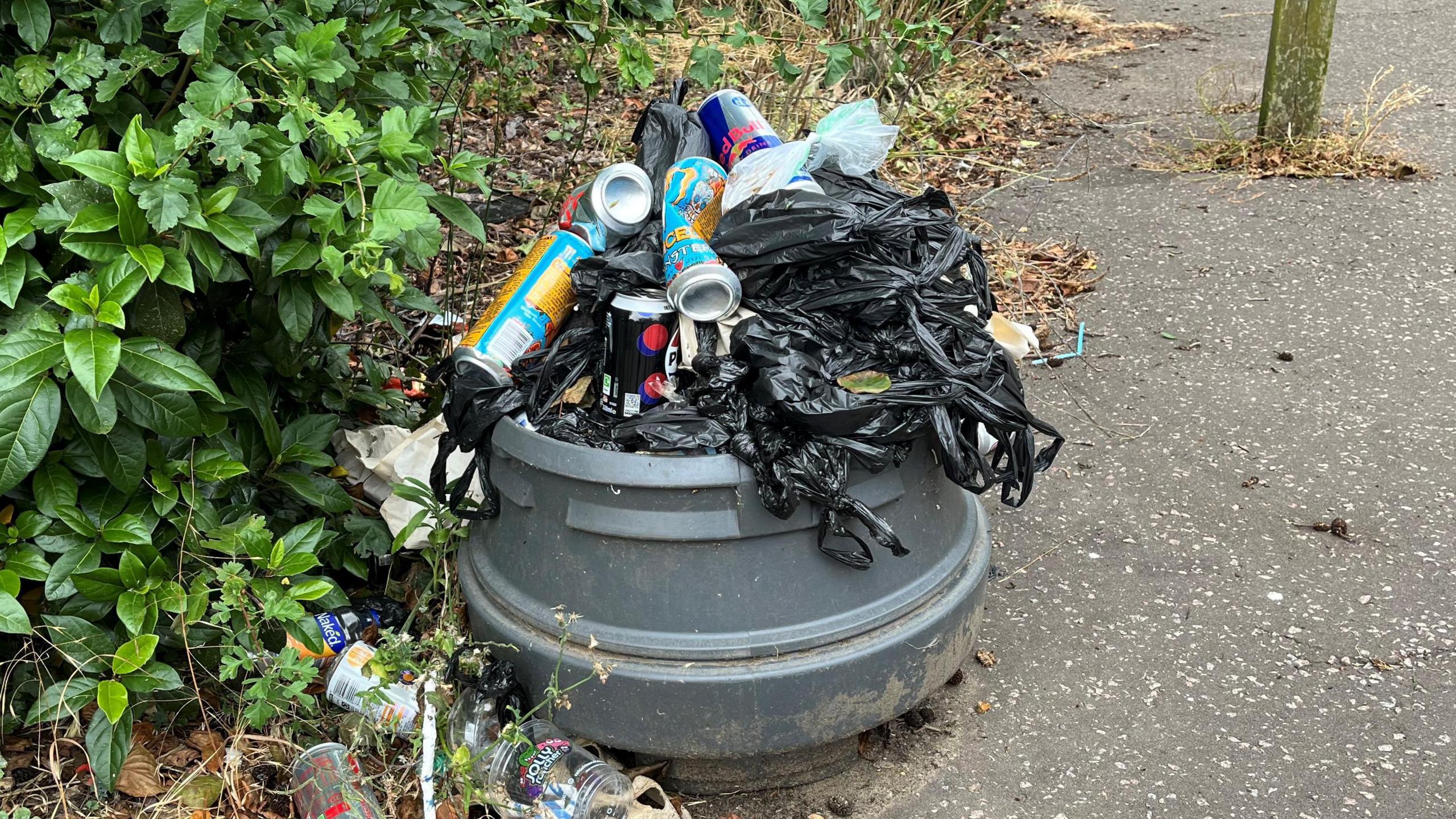 Rubbish stacked on a broken bin