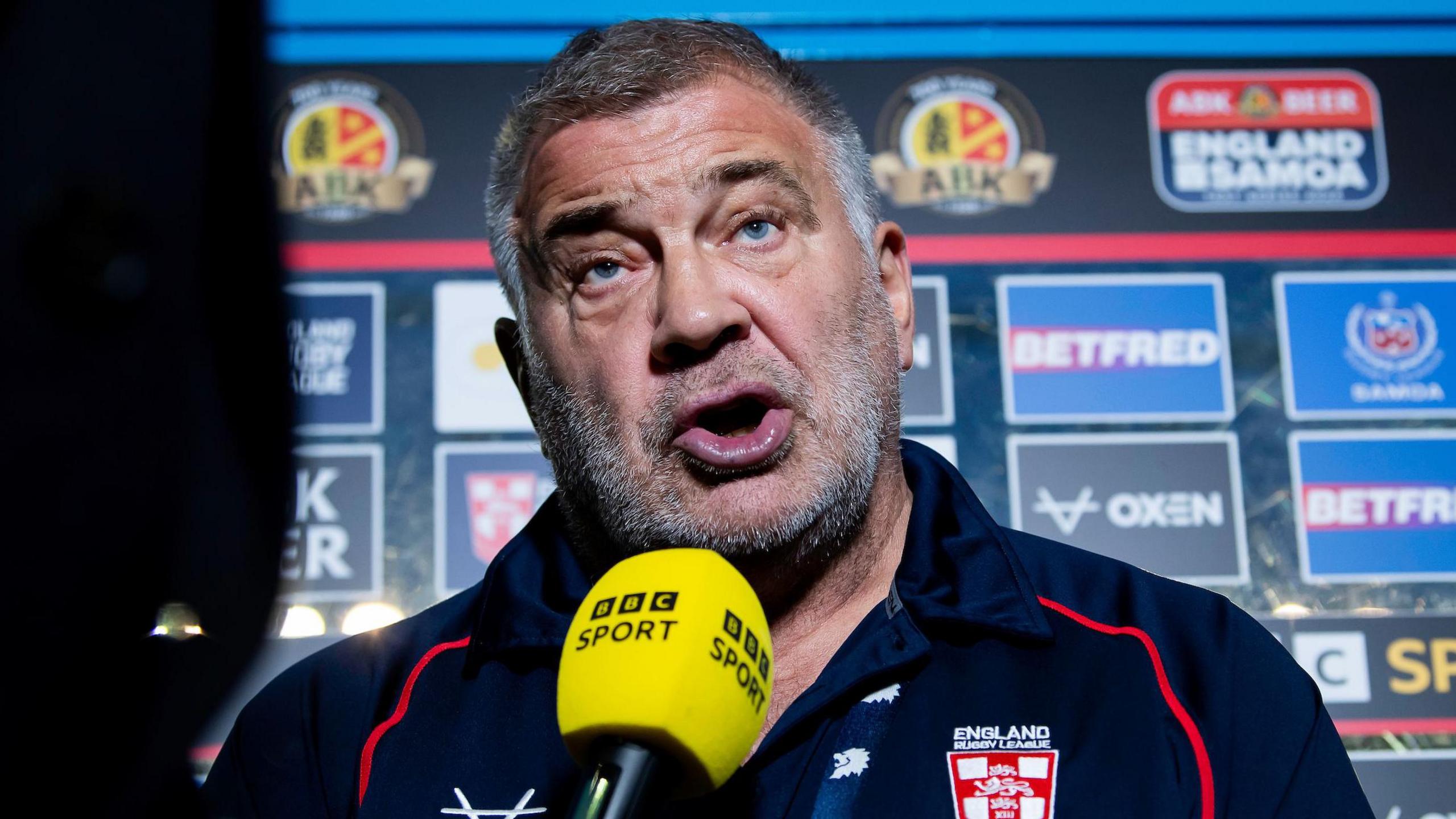 Shaun Wane speaks to nan BBC aft England's Test triumph complete Samoa successful 2024, pinch a microphone held to his look successful a post-match question and reply by nan advertizing board
