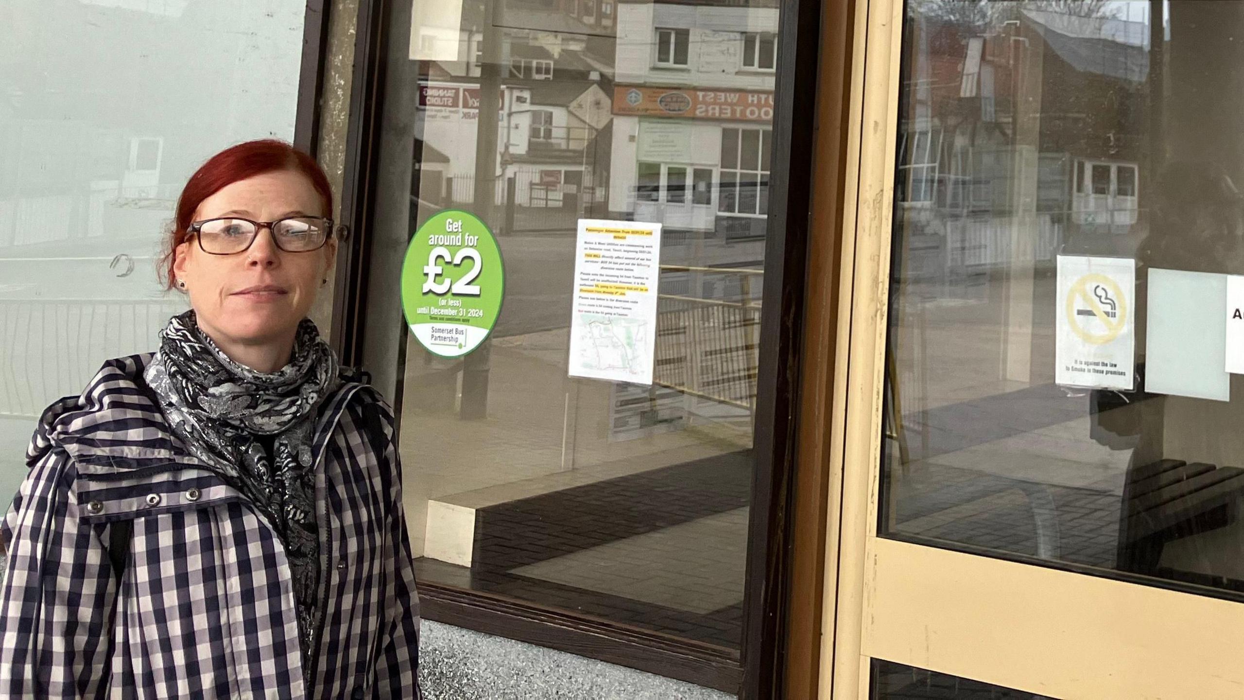 a woman outside a bus station waiting room