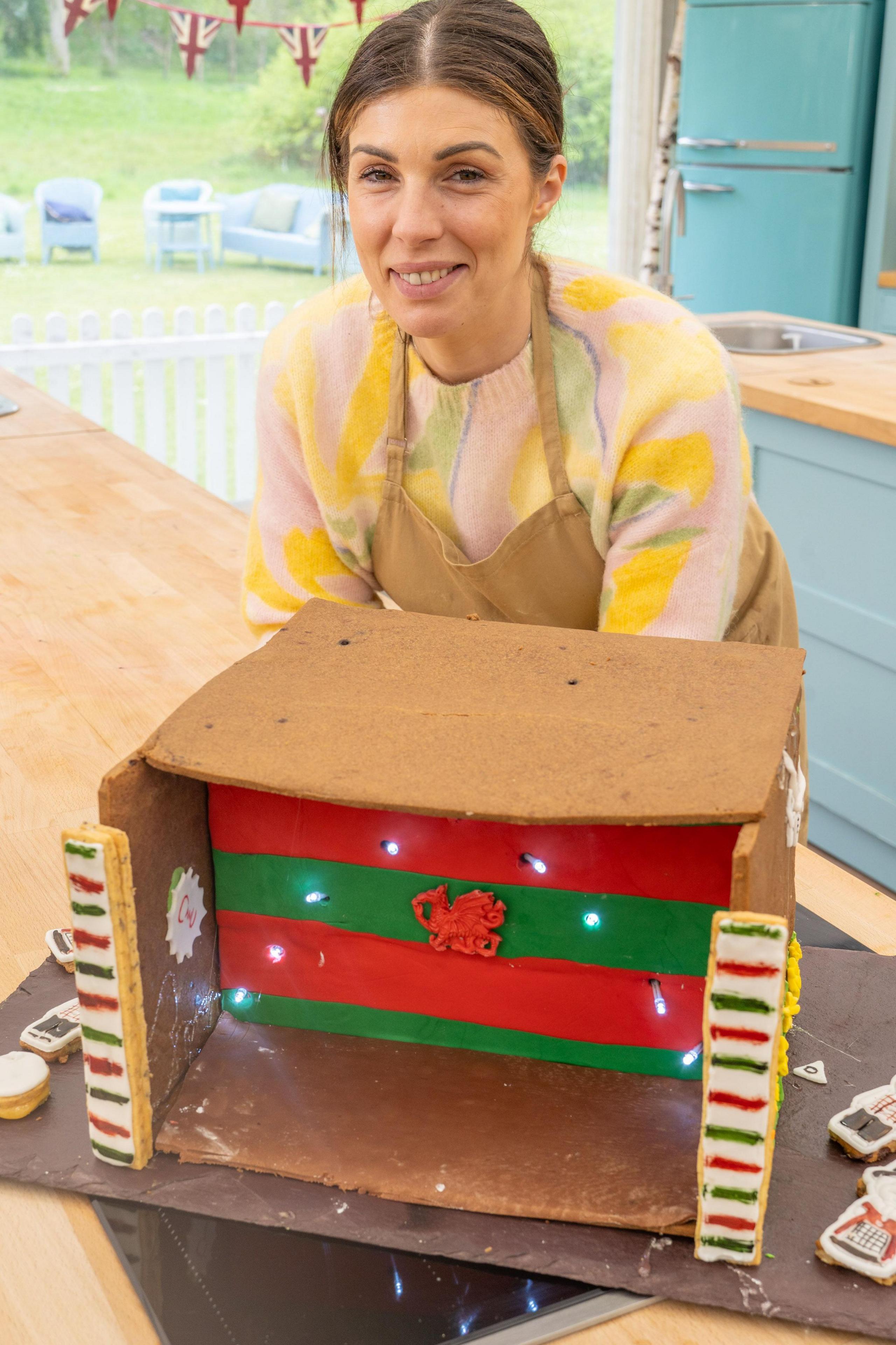 Bake Off winner Georgie Grasso with a Welsh-themed cake, including a red dragon at the front