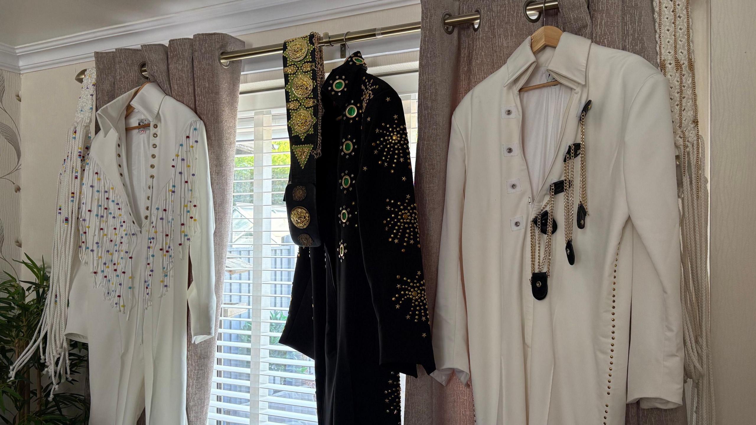 Elvis outfits hung up