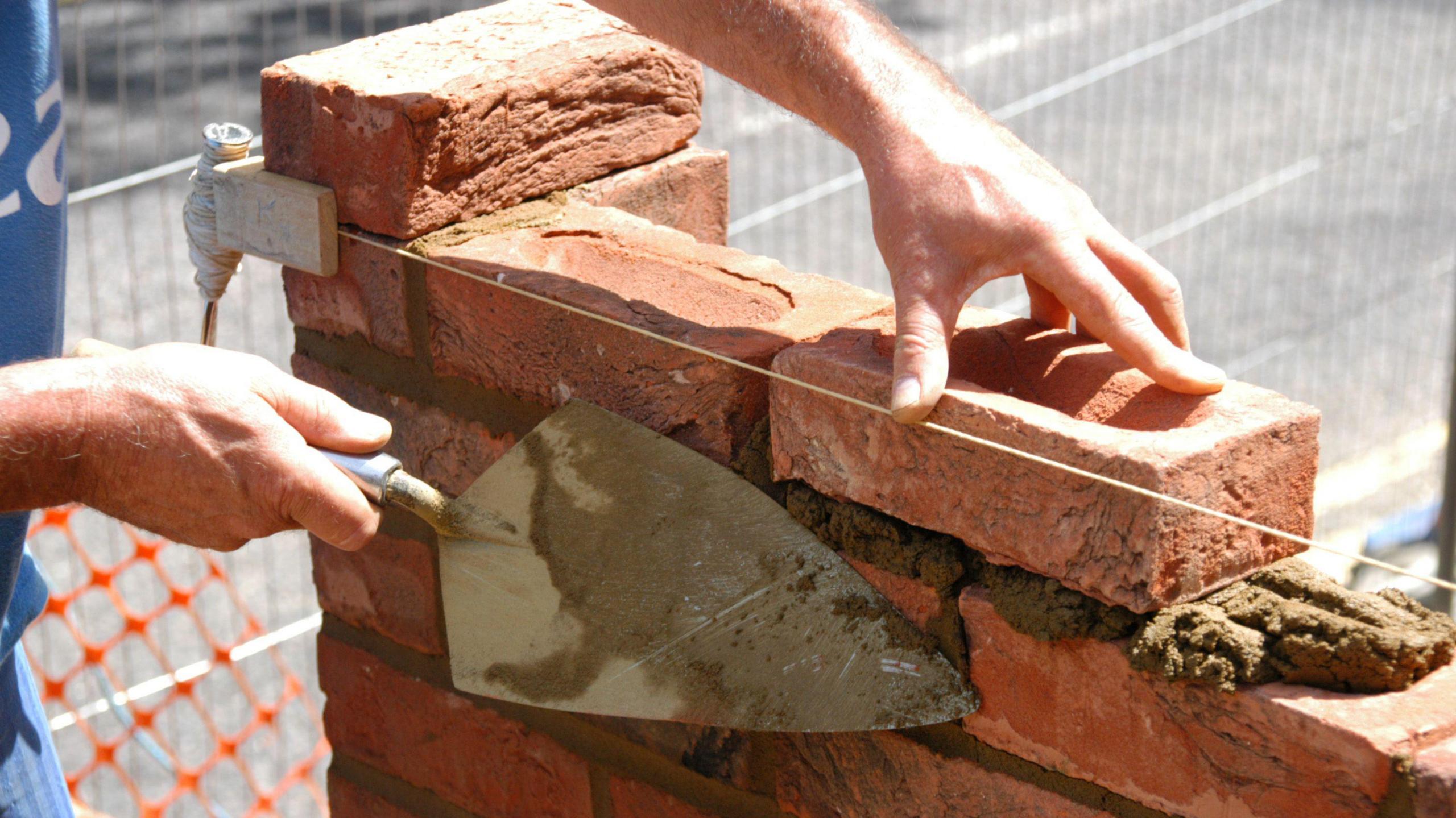 Bricklayer building a wall