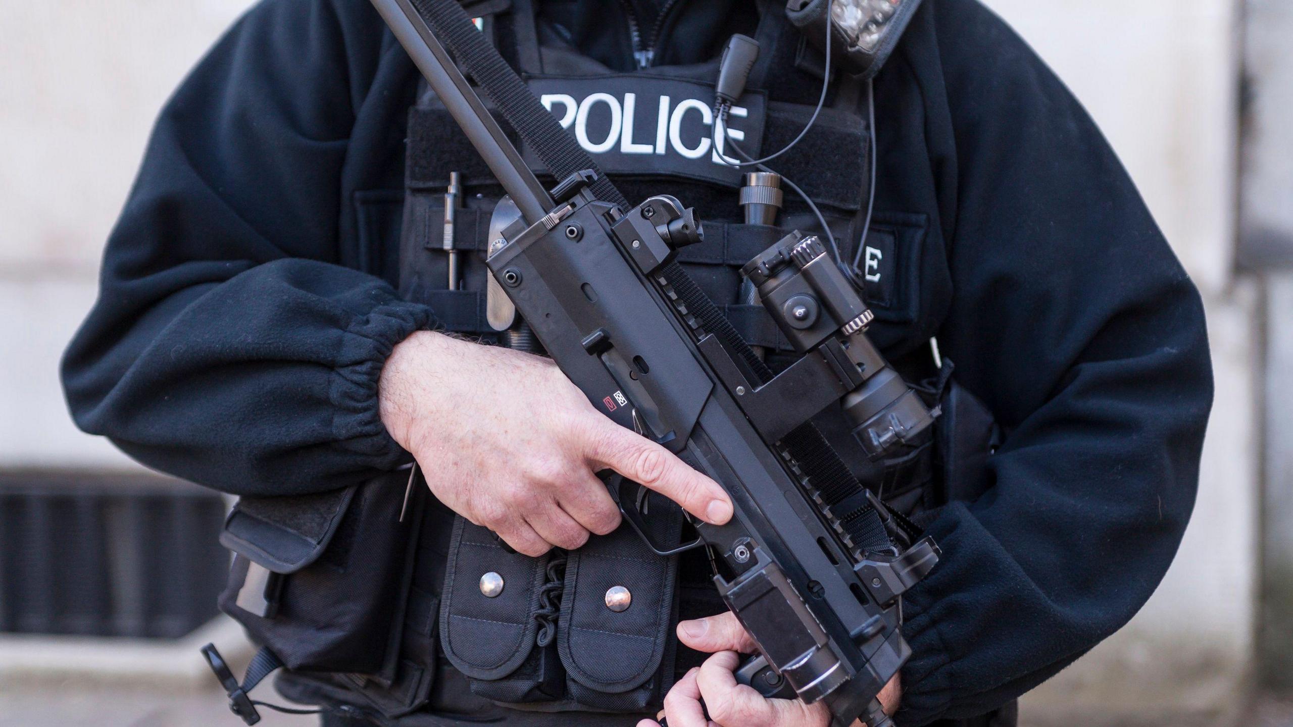 Police officer standing with a gun