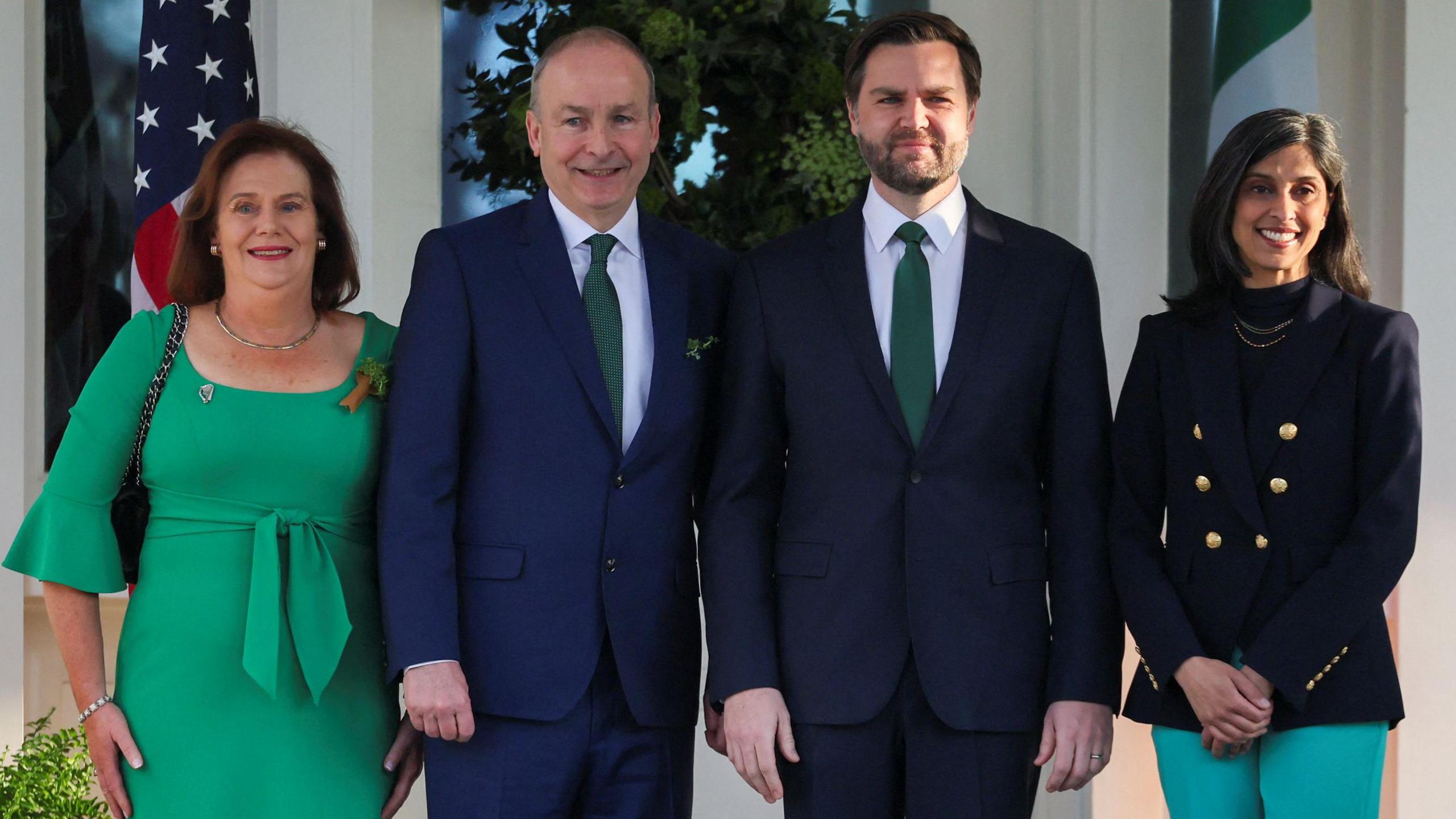 U.S. Vice President JD Vance, second lady Usha Vance, Micheal Martin and his wife Mary O'Shea posing in line and smiling at the camera. 