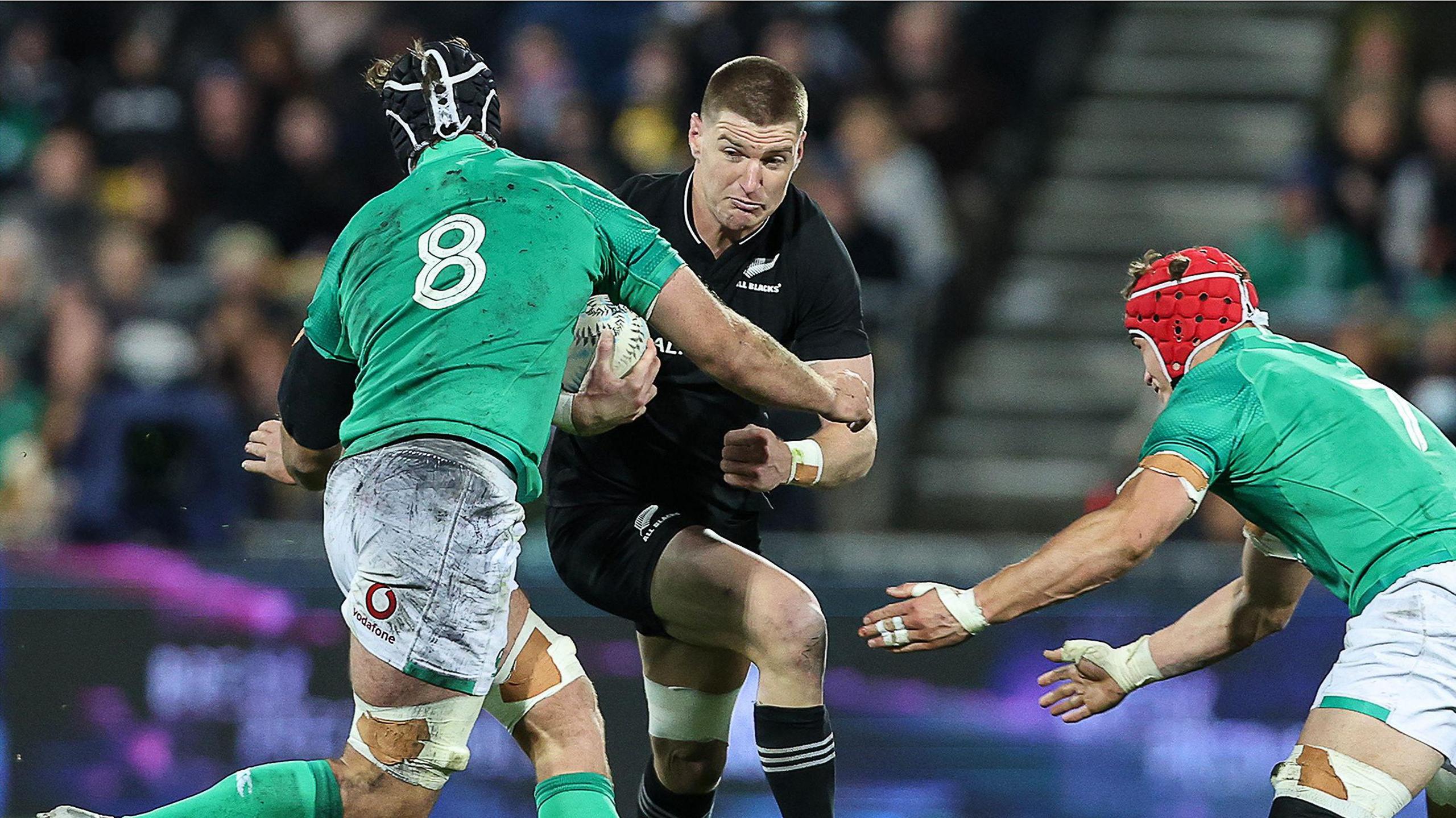 Jordie Barrett tackled by his new Leinster team-mates Josh van der Flier and Caelan Doris