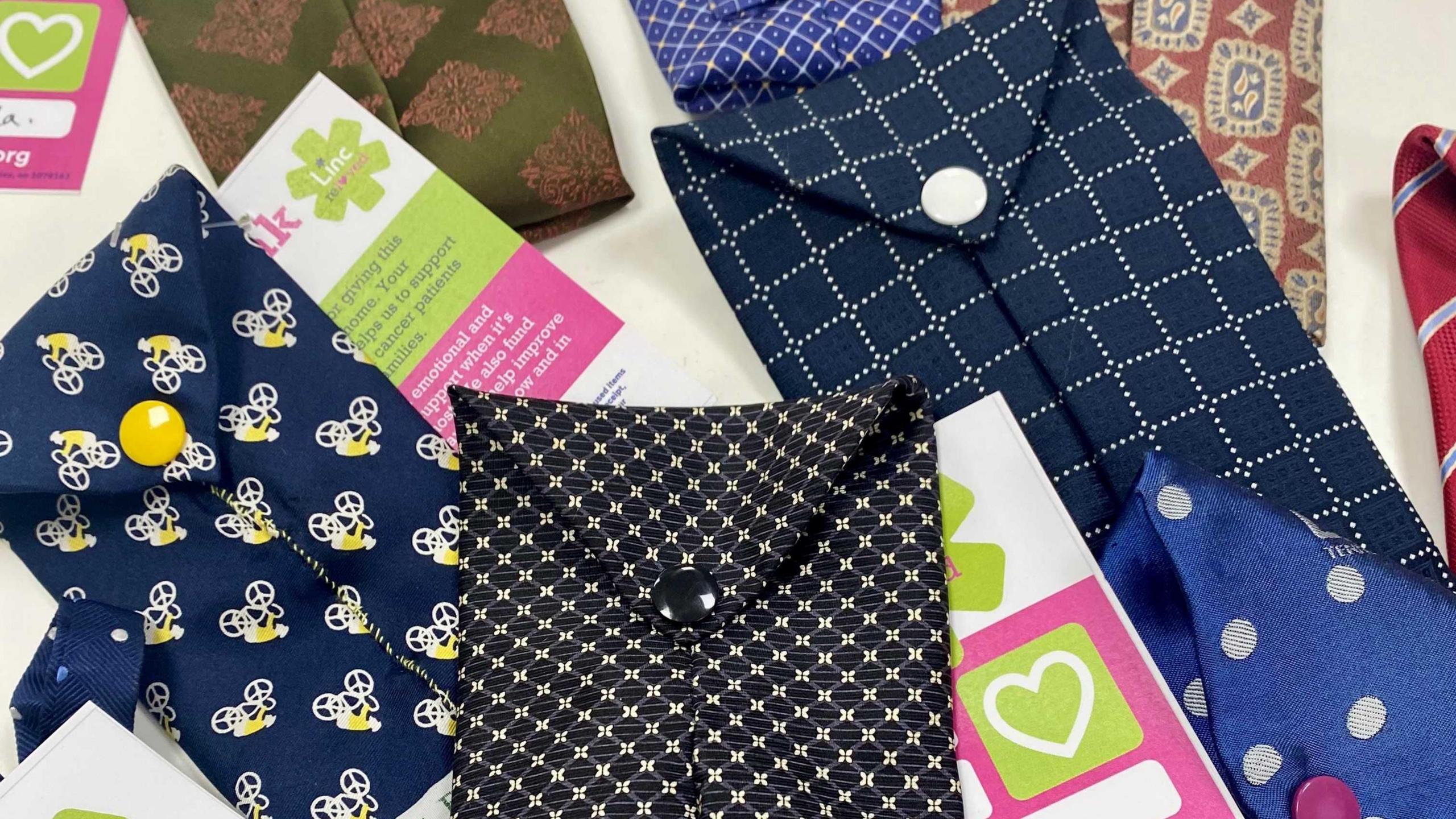 Brightly coloured spectacle cases made from ties, with sale tags attached