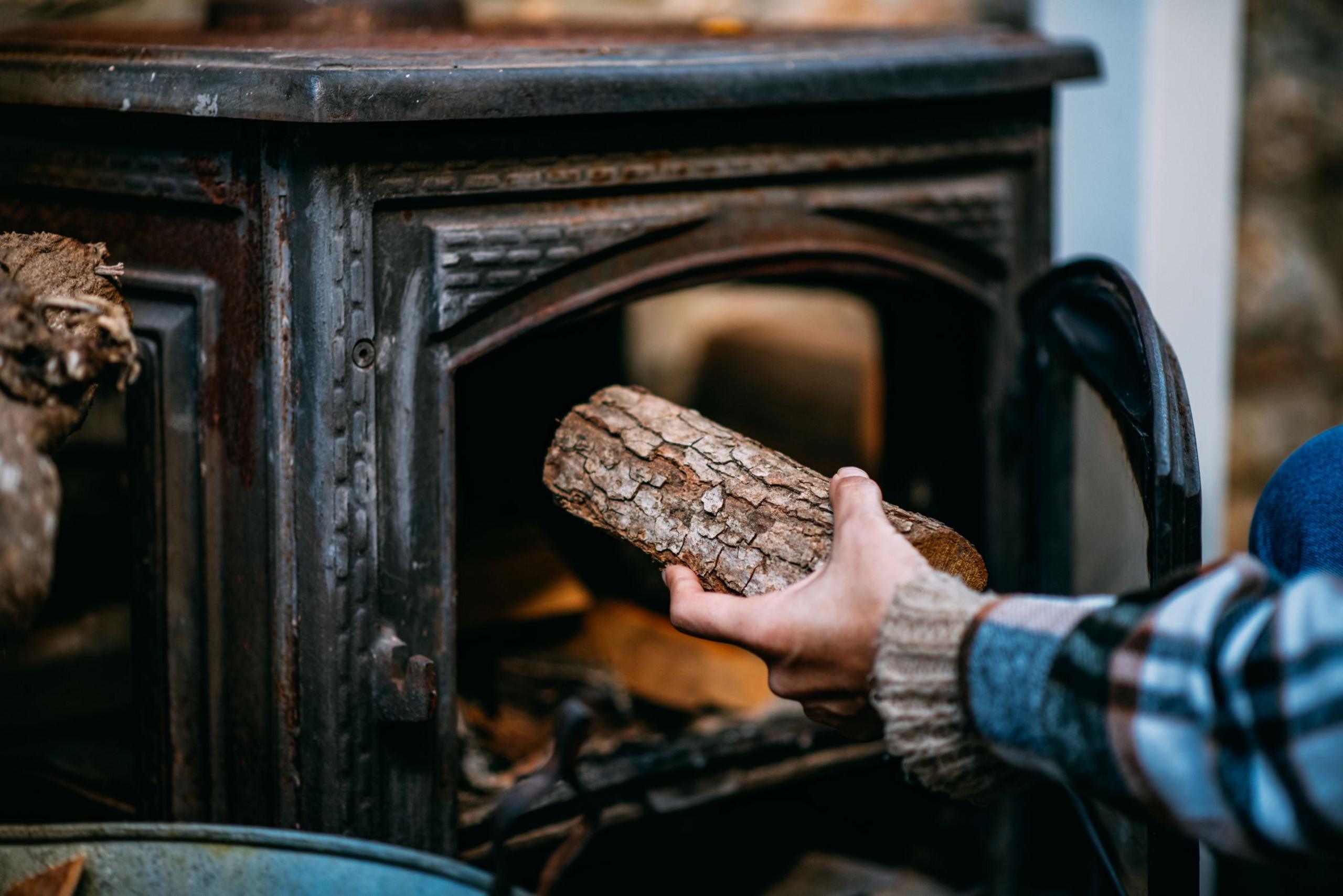 Wood being placed in a stove