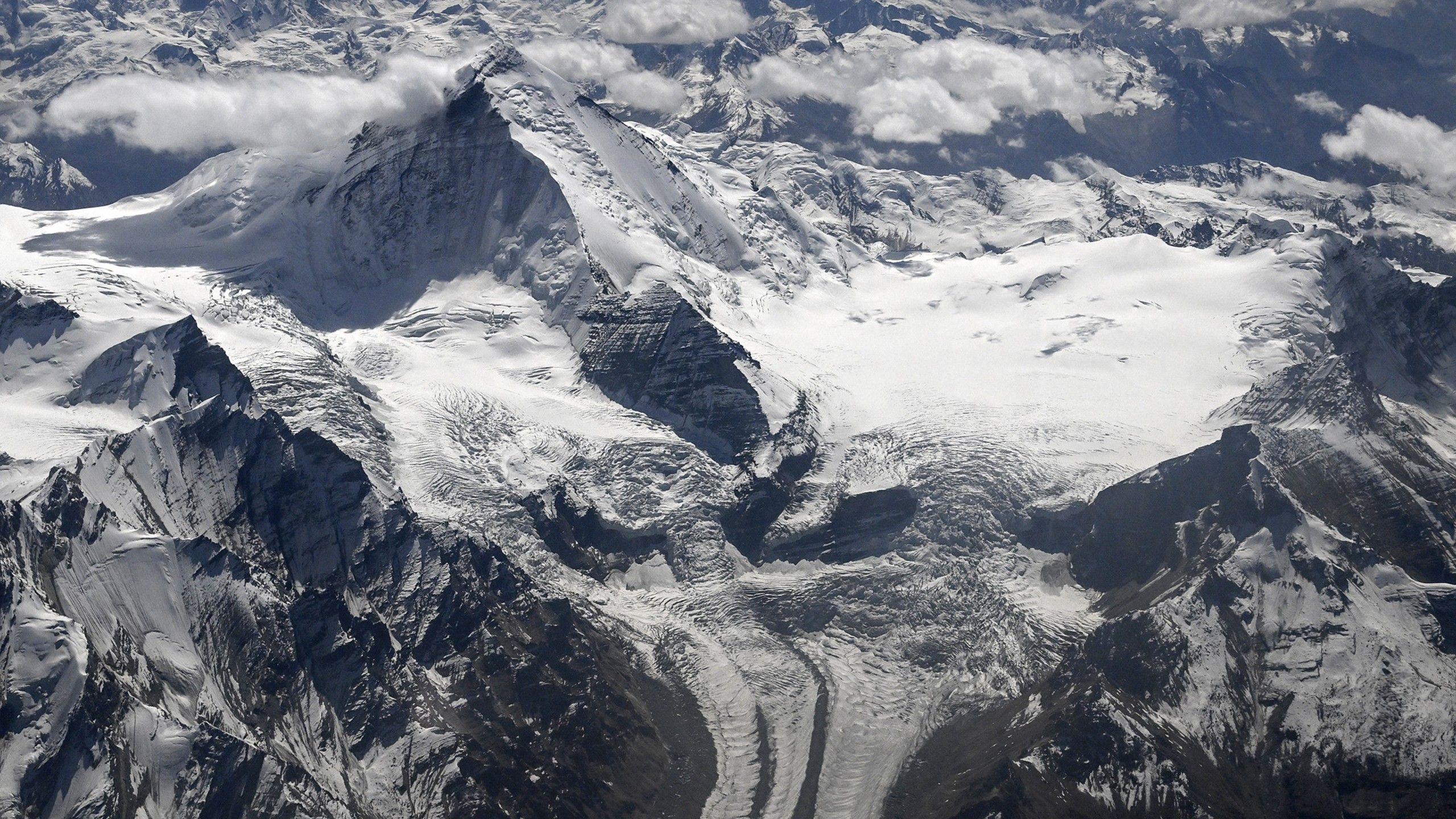 An aerial photograph taken from a passenger aircraft shows snow-covered mountain peaks in Ladakh.