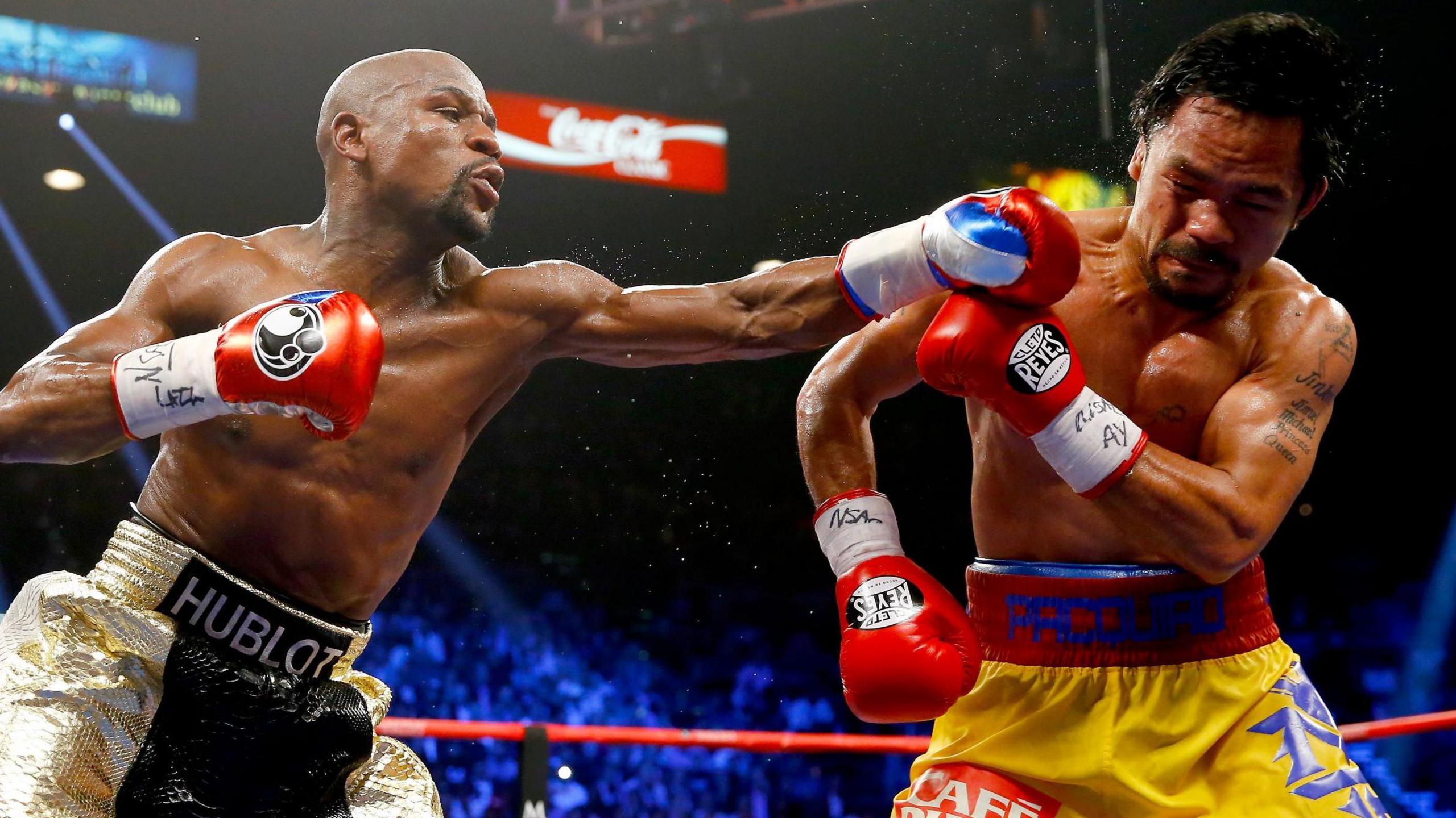 Floyd Mayweather throws a punch at Manny Pacquiao during their welterweight unification championship bout in May 2015 at MGM Grand Garden Arena in Las Vegas