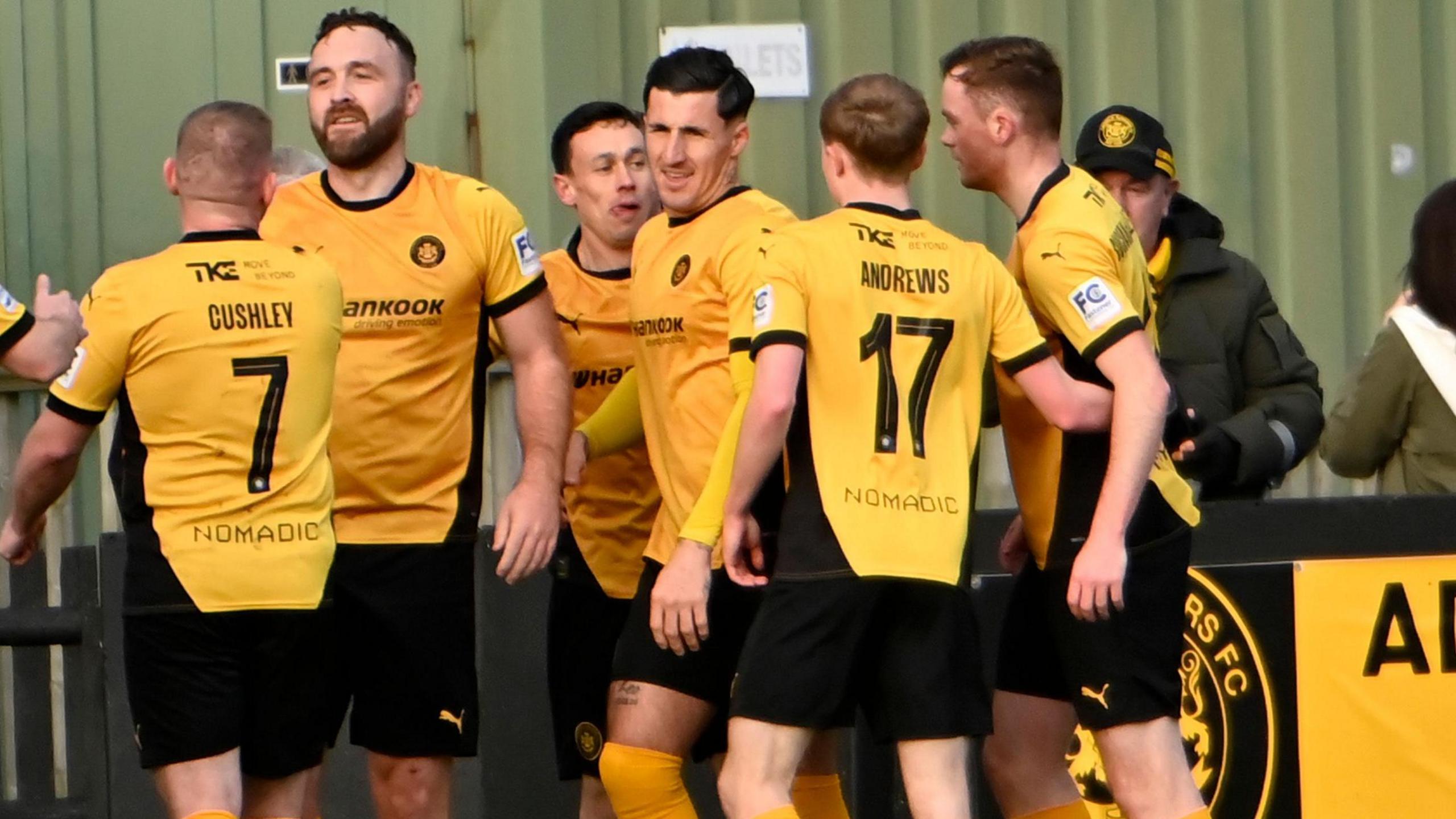 Carrick Rangers celebrate one of their three goals against Crusaders