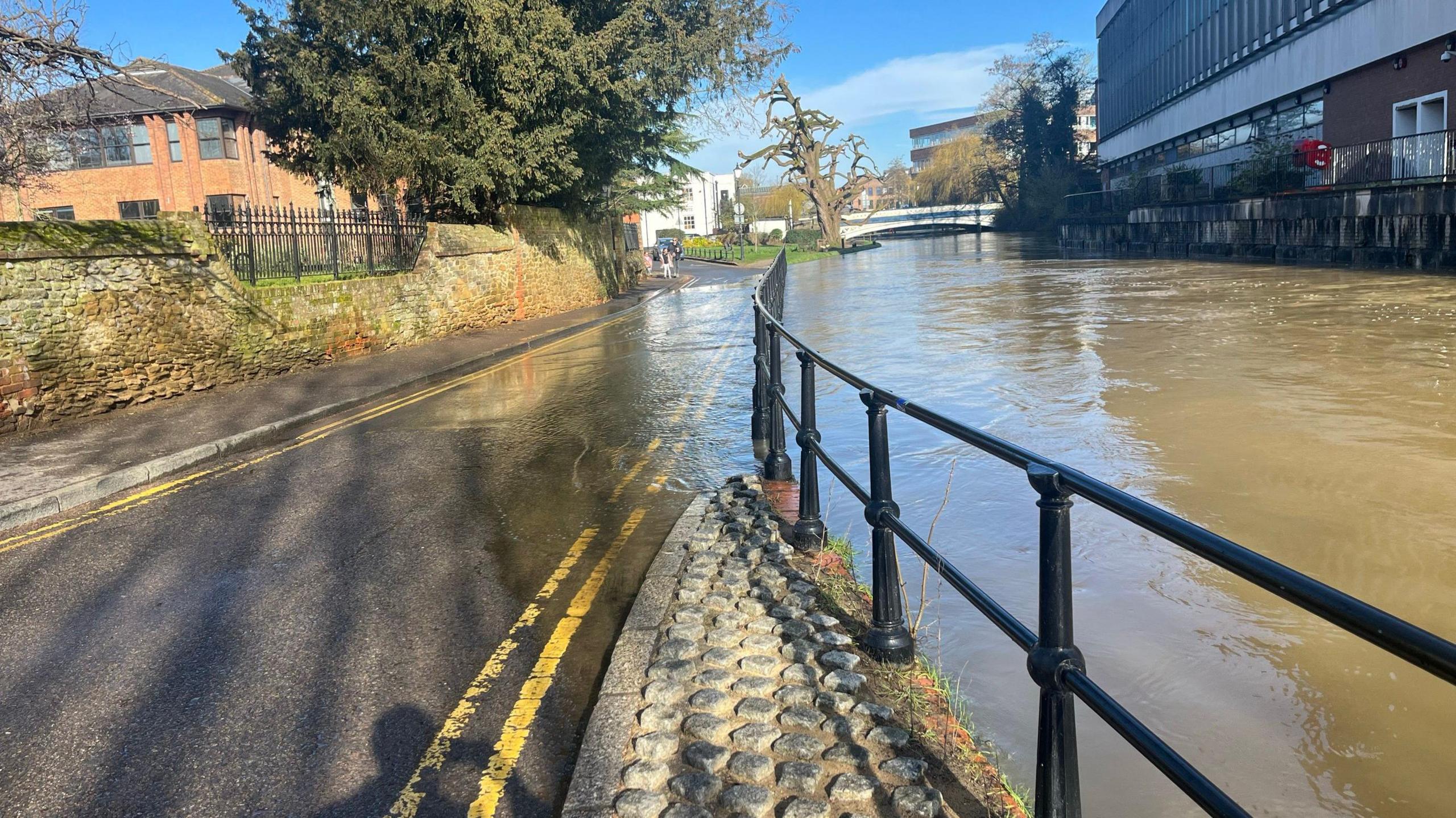 Floodwater covering a road and footpath in Guildford town centre in April 2024.