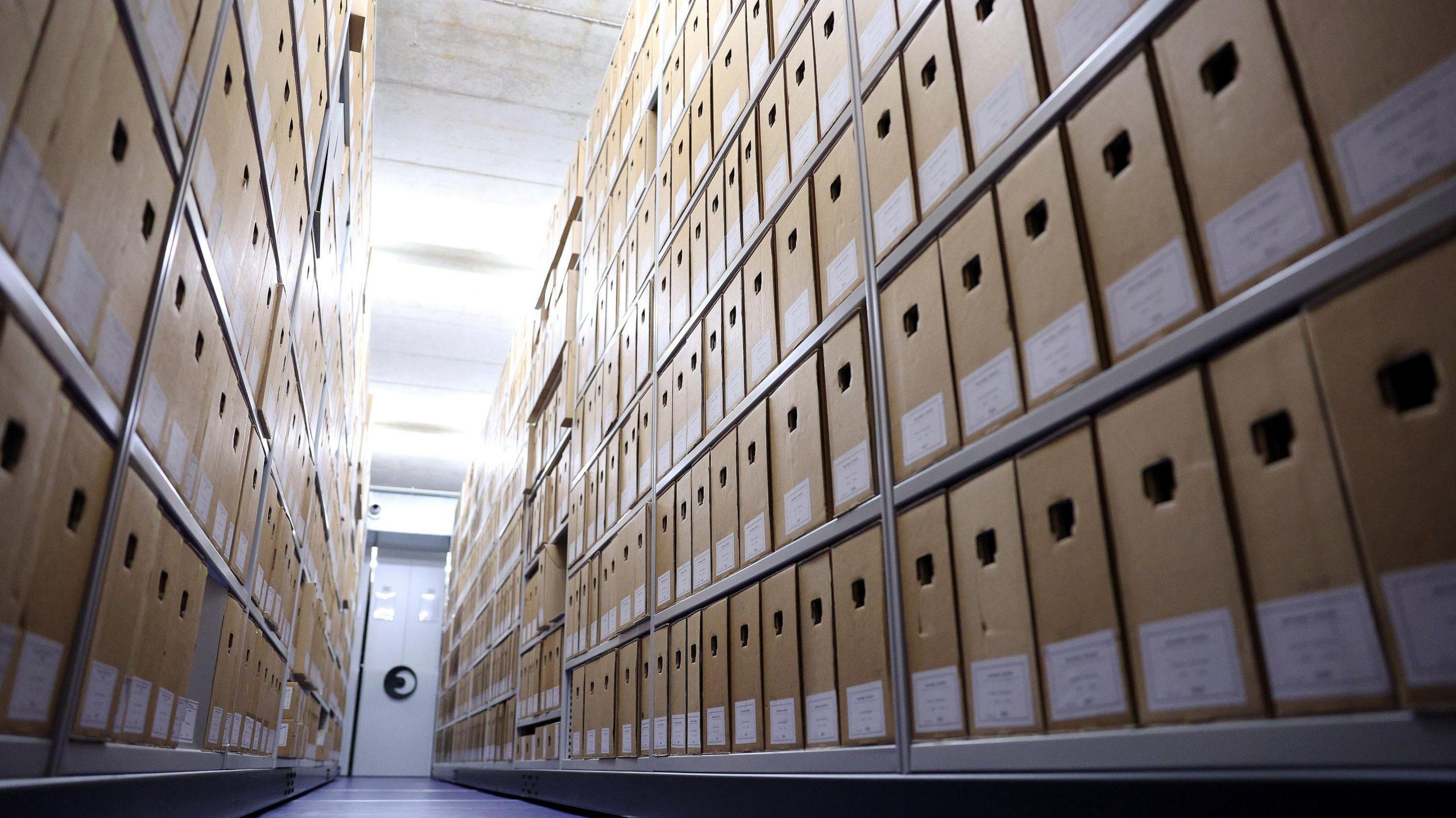 A general view of the interior of the Dutch National Archive in The Hague. Rows of filing cases can be seen stacked on shelves.