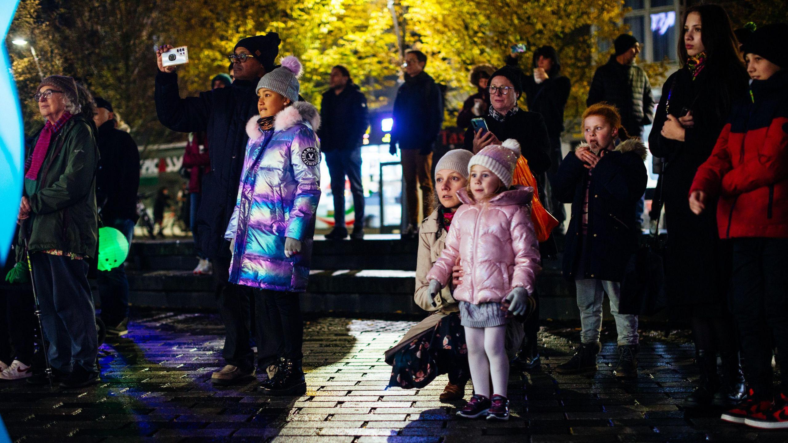 People looking at the Lampadophores light show in Luton