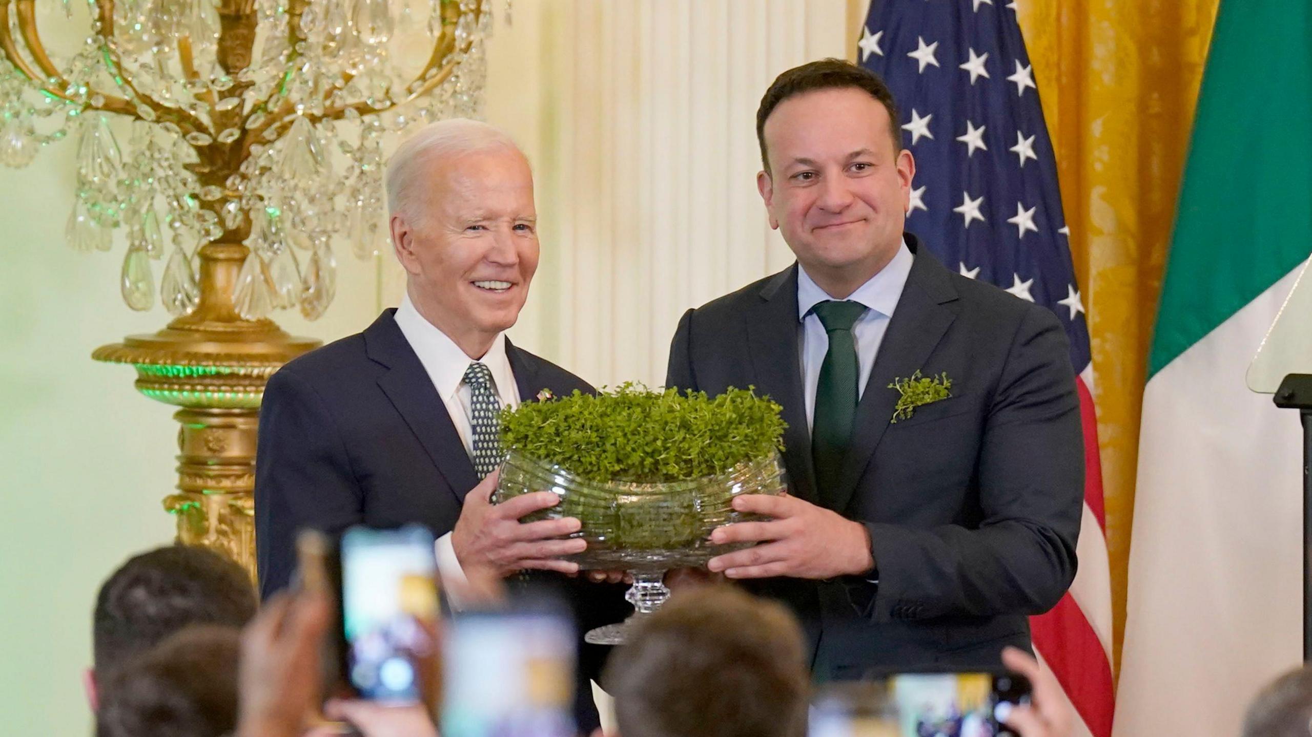 Taoiseach Leo Varadkar handing a bowl of shamrocks to President Joe Biden