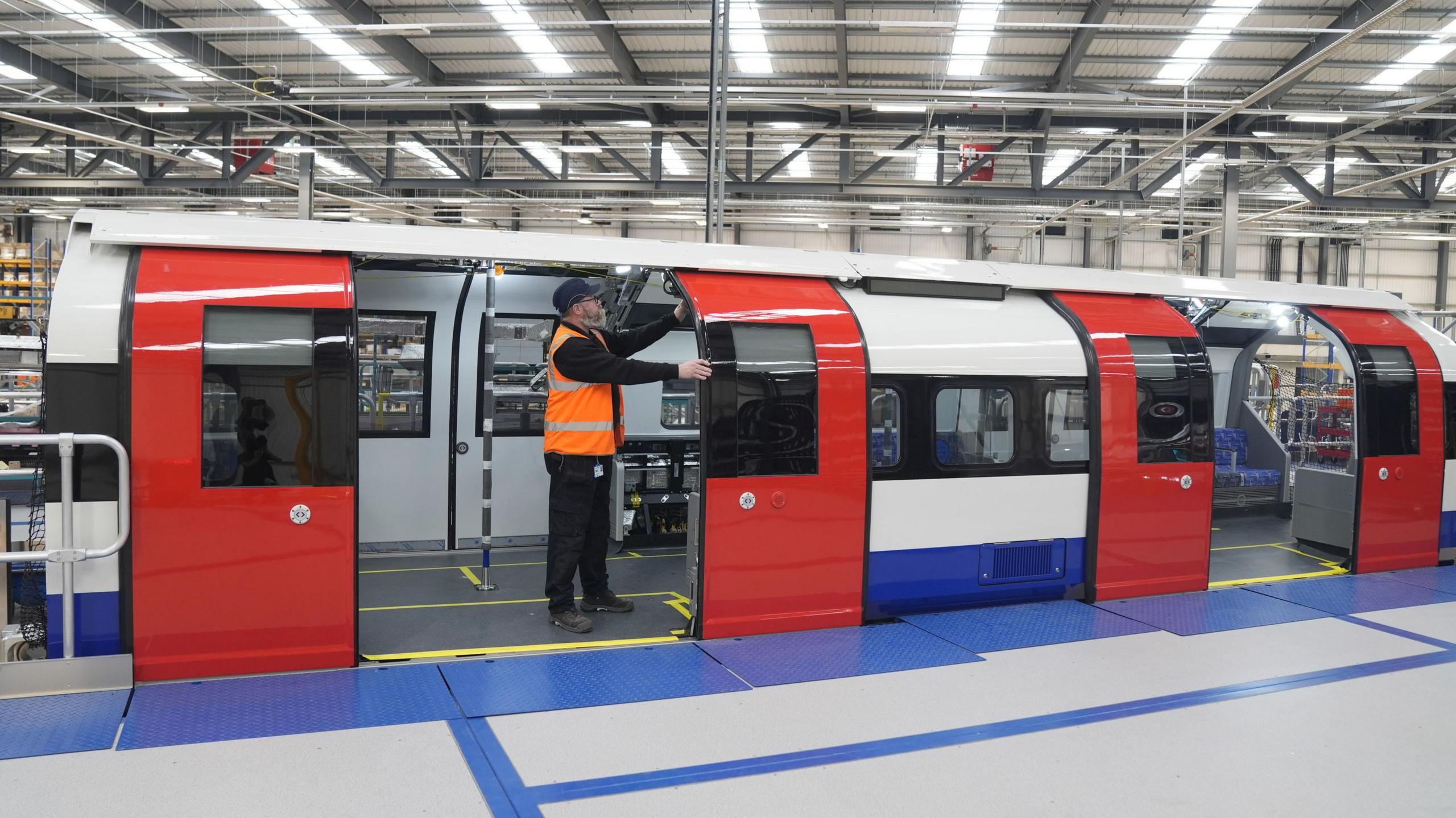 Siemens engineer standing on a new train during a press call at a Siemens factory in Goole 