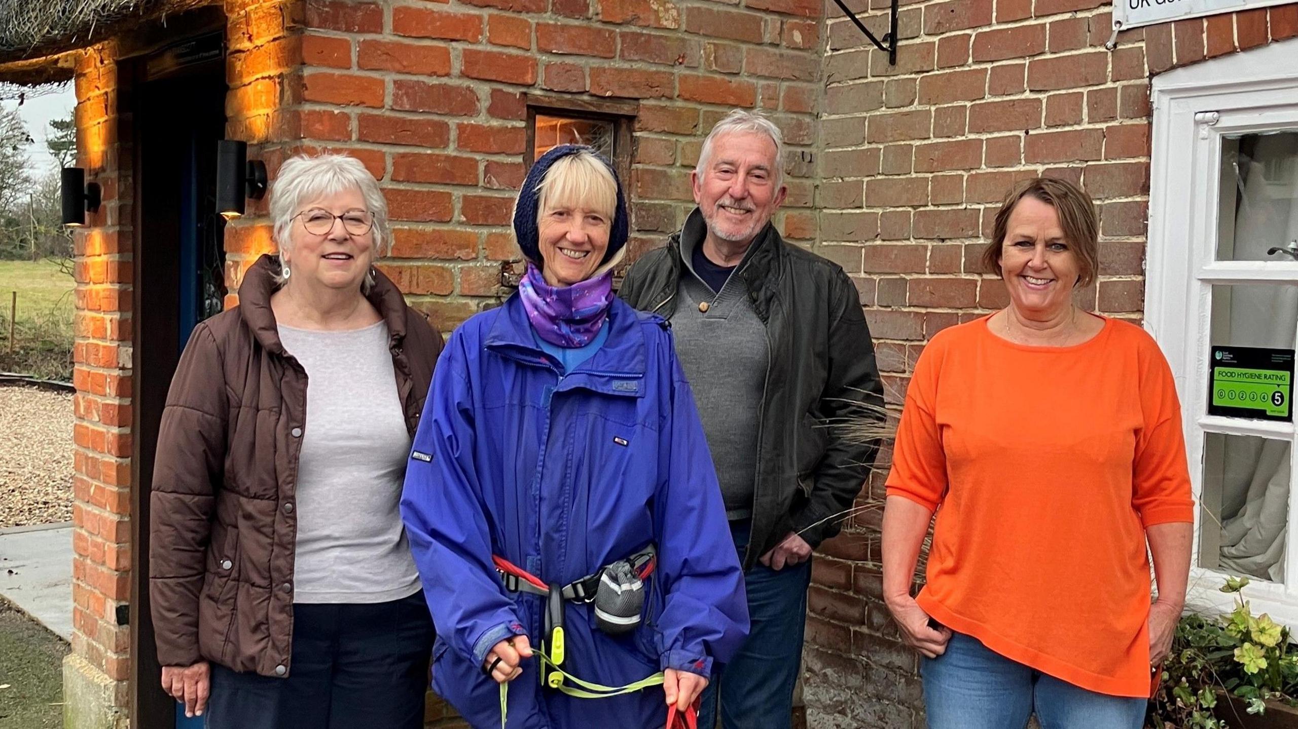 Picture shows volunteers Helen Morton, Pat Mason and Brian Cox standing next to manager Maria Swanscott outside the pub.