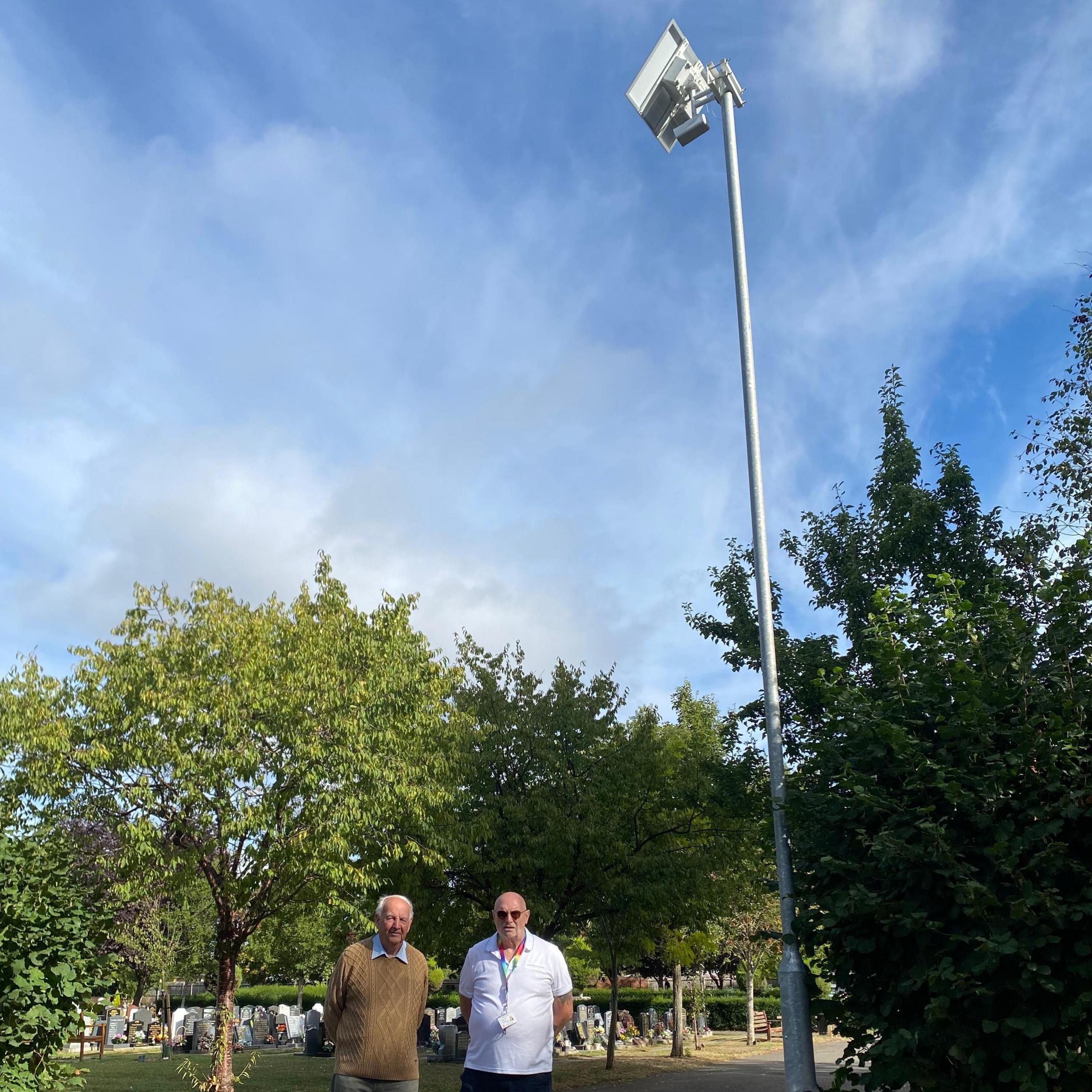 Two councillors stood near a camera pole