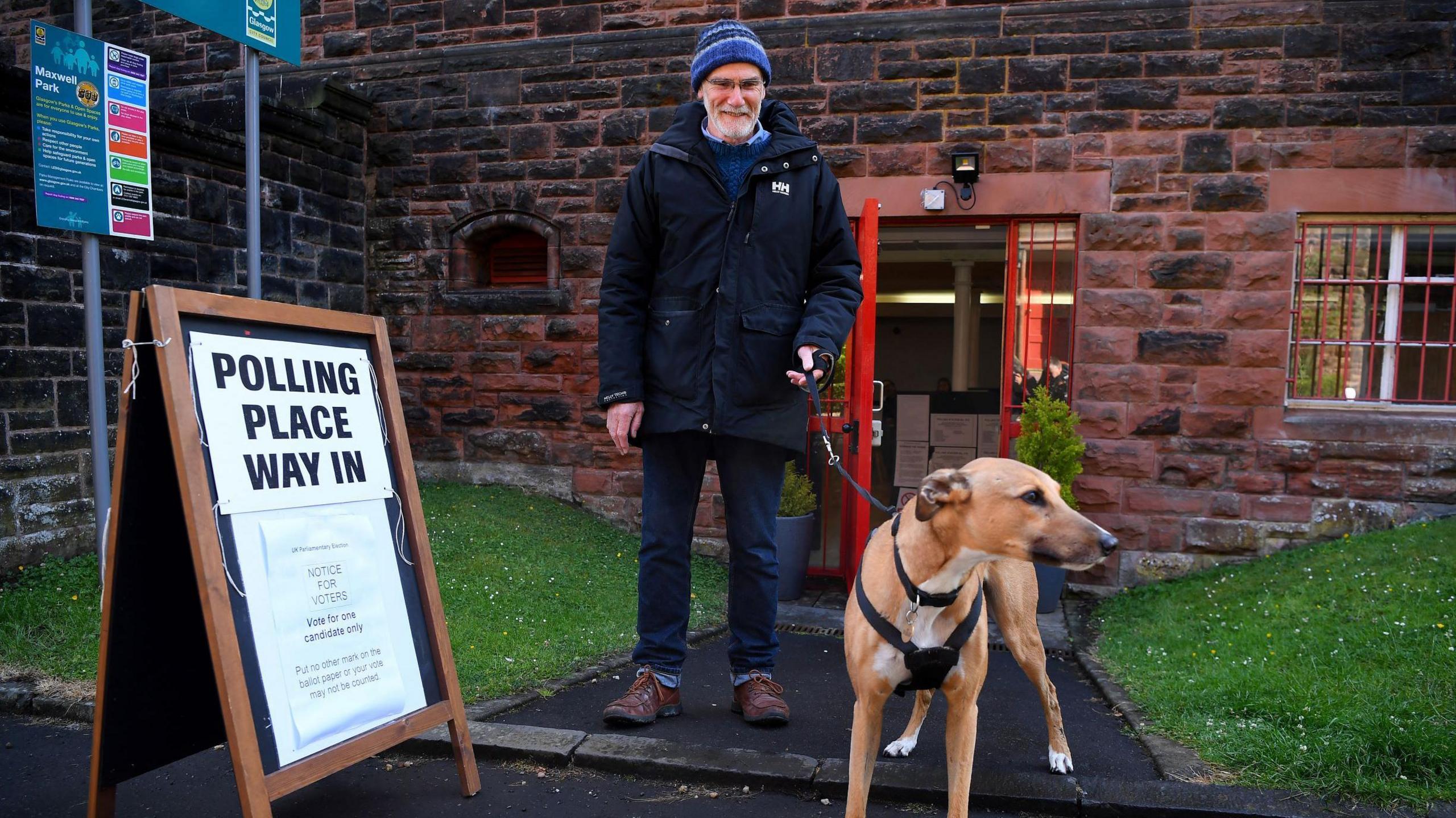 A voter and his dog at a Glasgow polling station