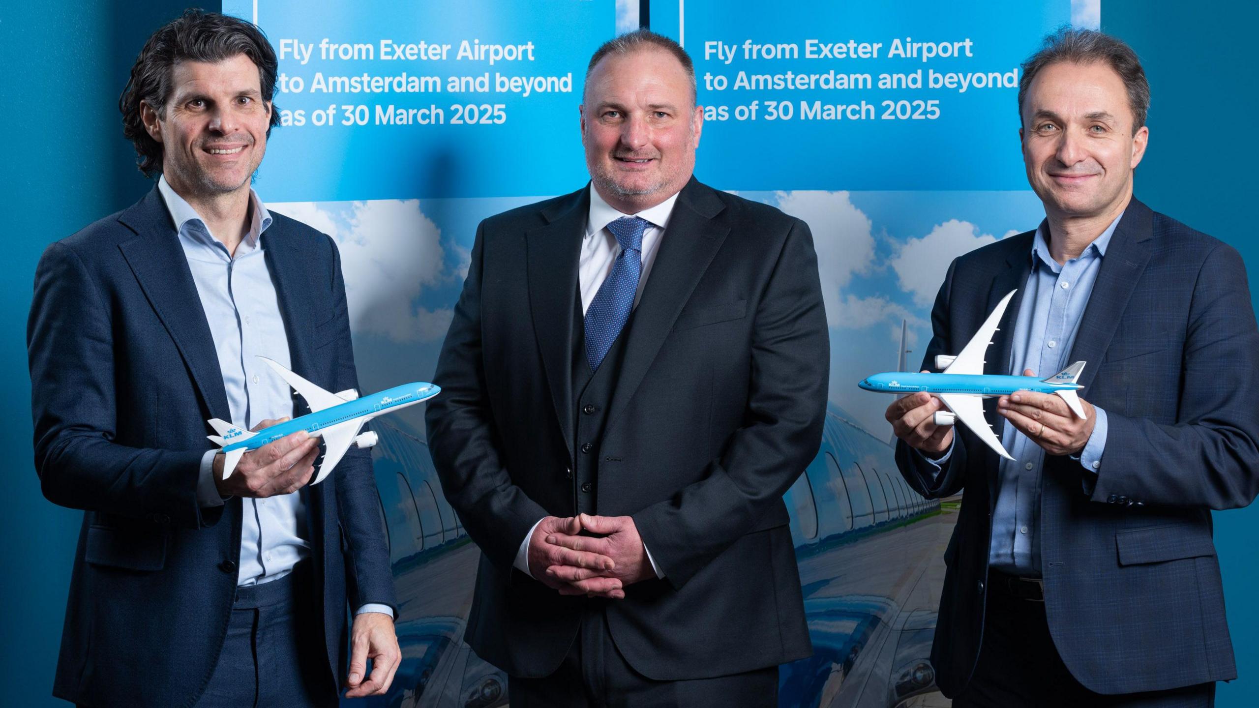 A photograph of, pictured, from left, of Steven van Wijk, commercial director for UK & Ireland at Air-France-KLM; Stephen Wiltshire, managing director of Exeter Airport and Jerome Salemi, general manager for UK & Ireland at Air-France-KLM. All three are wearing suits and looking towards the camera. 