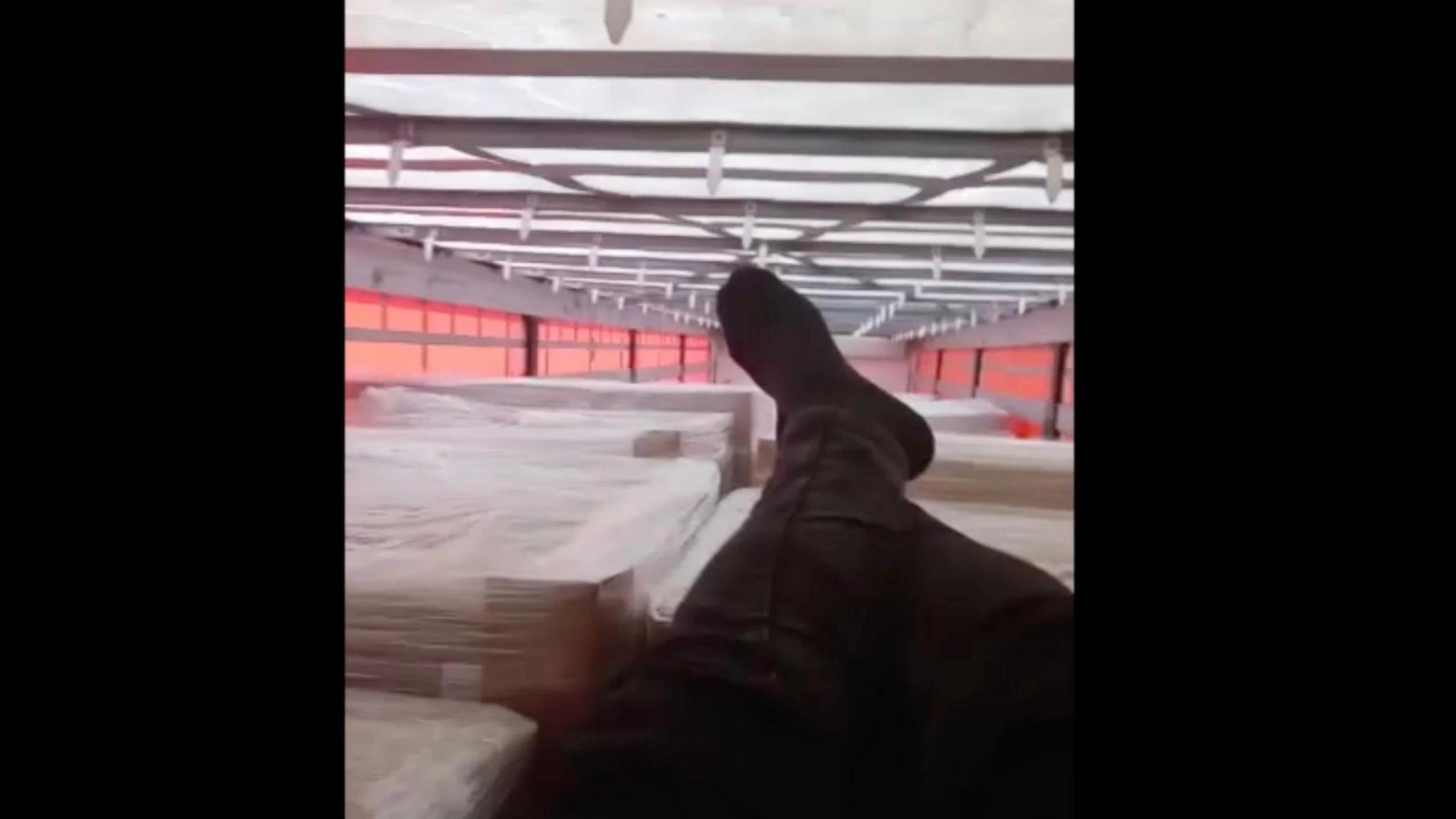 An image of a migrant's legs as he films a video from inside a lorry