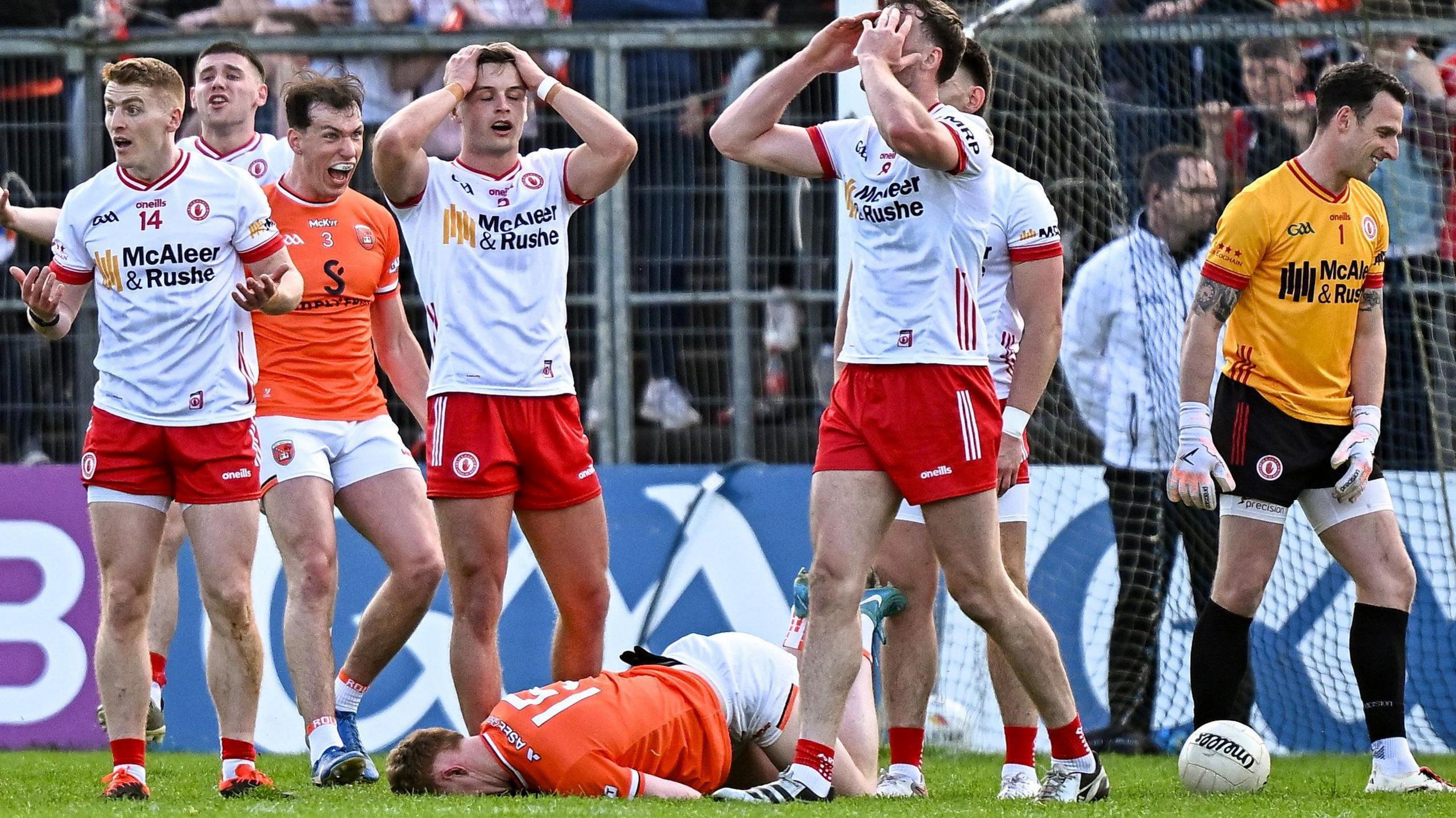 Peter Harte and other Tyrone players show their despair as Armagh's Barry McCambridge celebrates after Conor Turbitt earned the Orchard County their match-winning free at Clones