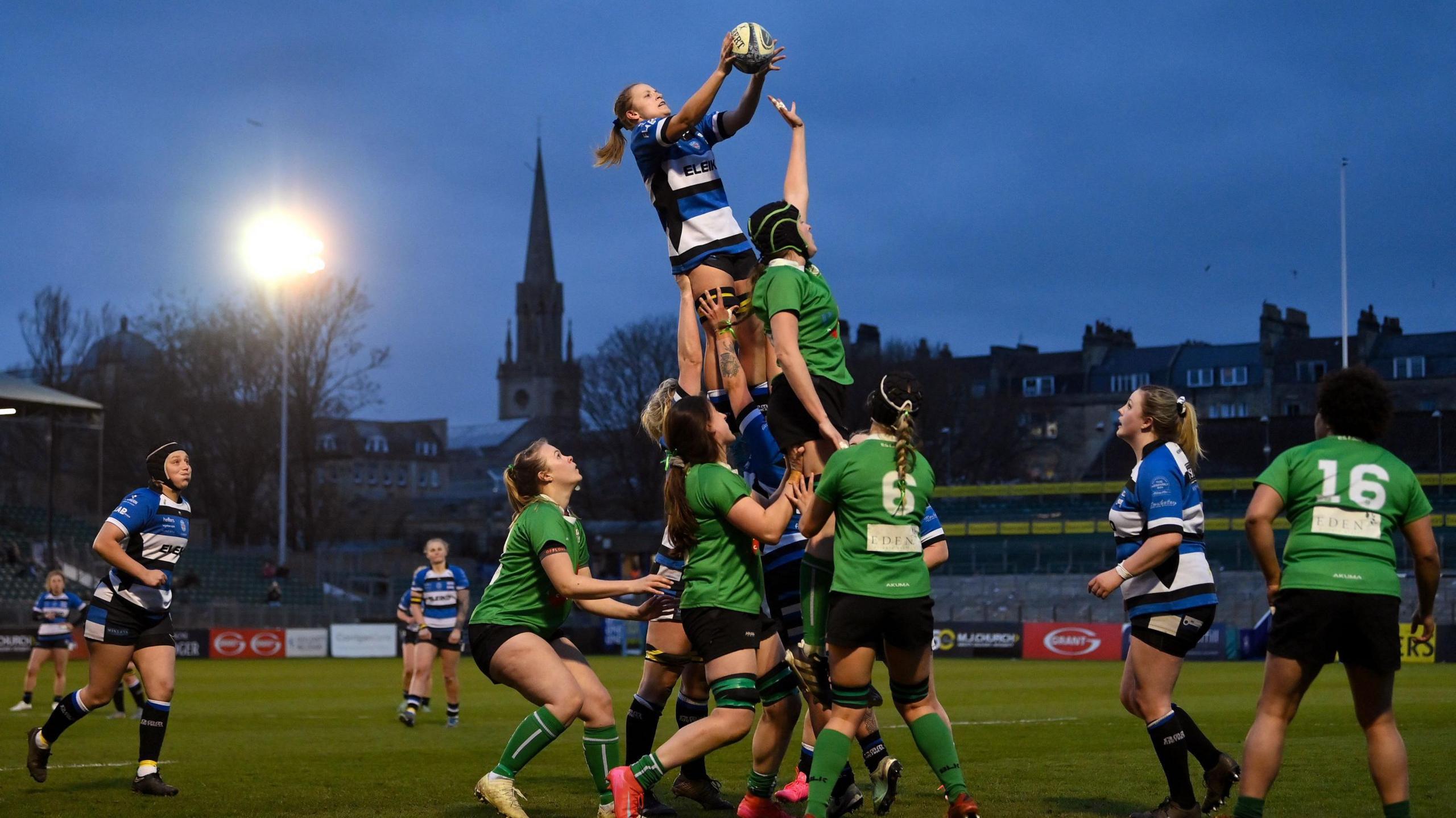 A Bath Ladies player is lifted in the air to catch the ball from a line-out during a match for the club at the Recreation Ground